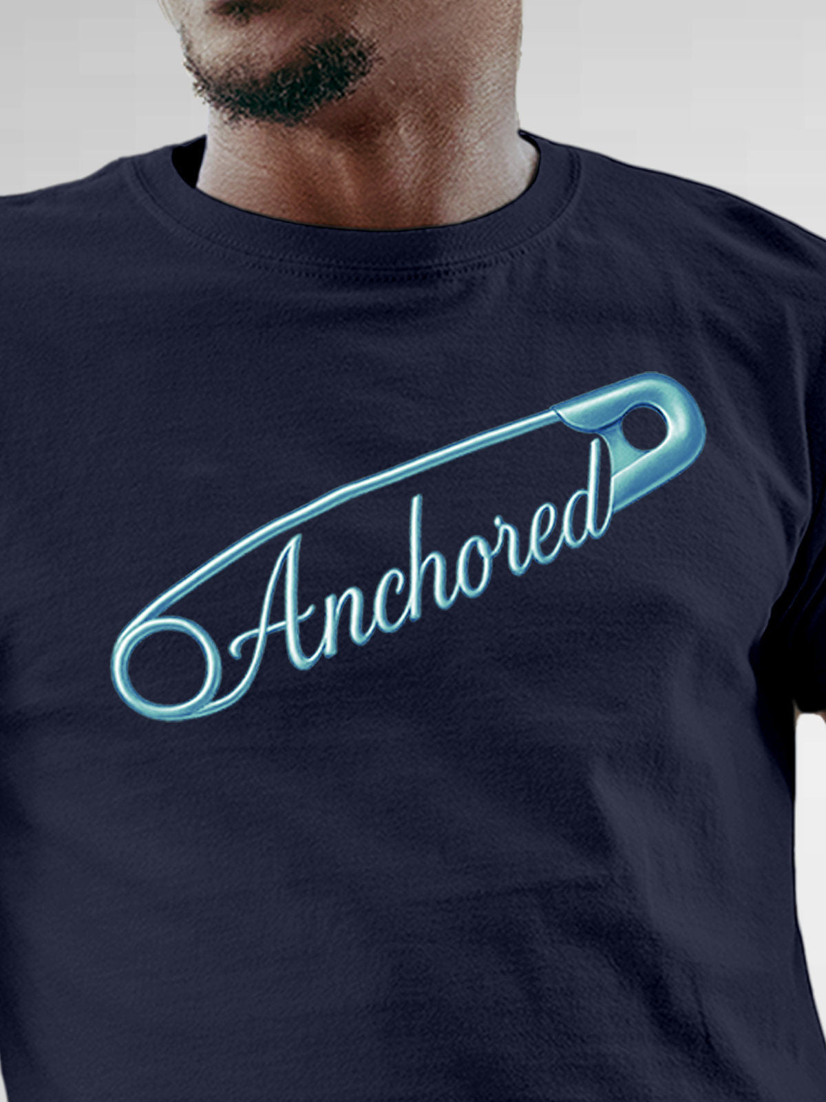 Close up of 'Anchored' design on Men's Navy Blue Round Neck T-shirt, highlighting intricate details and vibrant print.