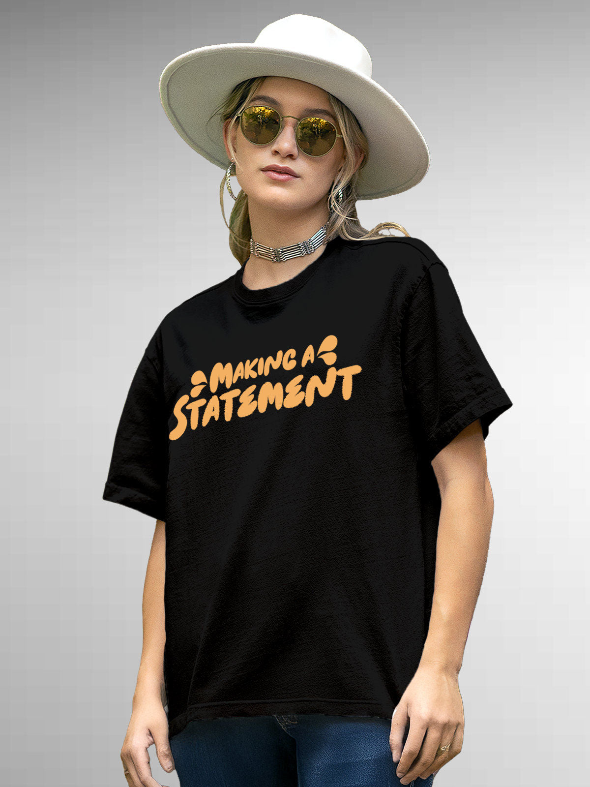 Model wearing Women's Black Round Neck T-shirt with 'Making A Statement' design, offering effortless style and premium comfort