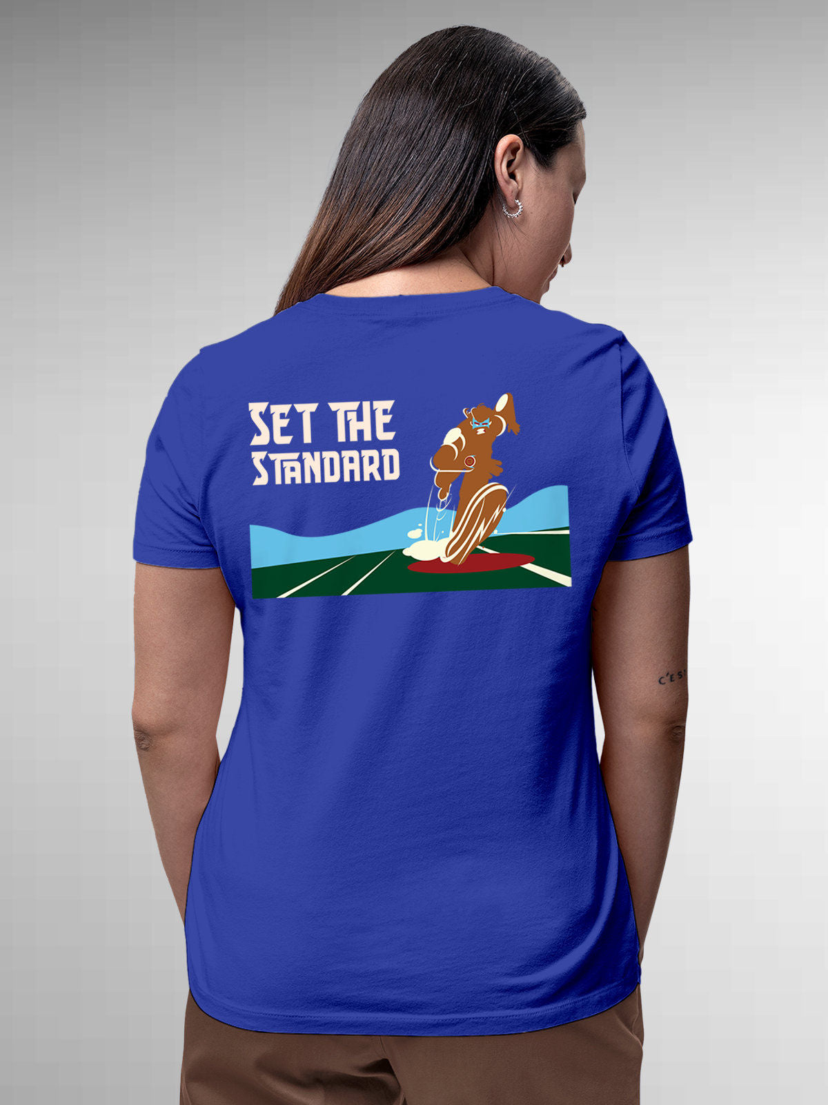 Model wearing Women's Blue Round Neck T-shirt with 'Set The Standard' design, offering effortless style and premium comfort