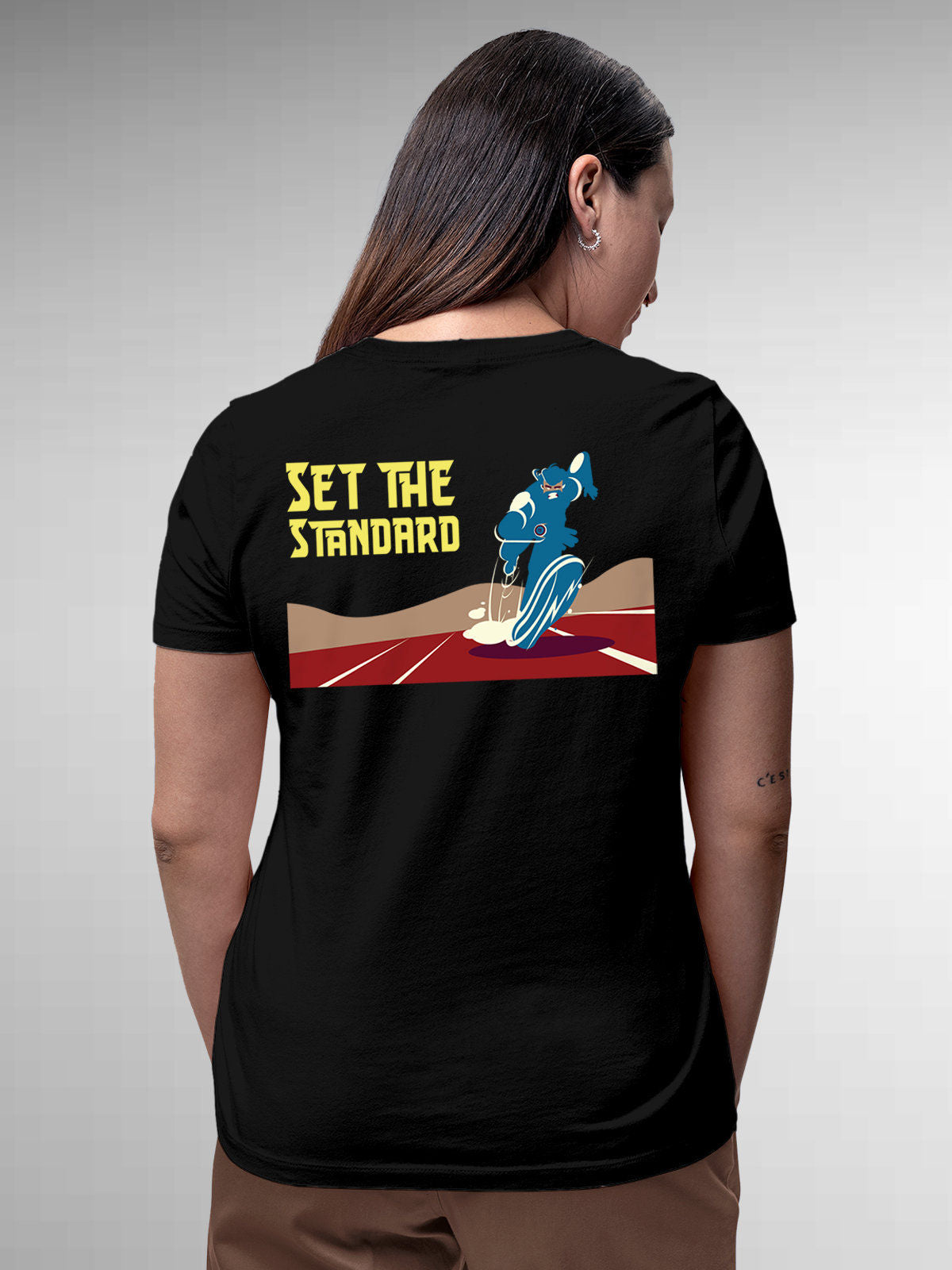 Model wearing Women's Black Round Neck T-shirt with 'Set The Standard' design, offering effortless style and premium comfort