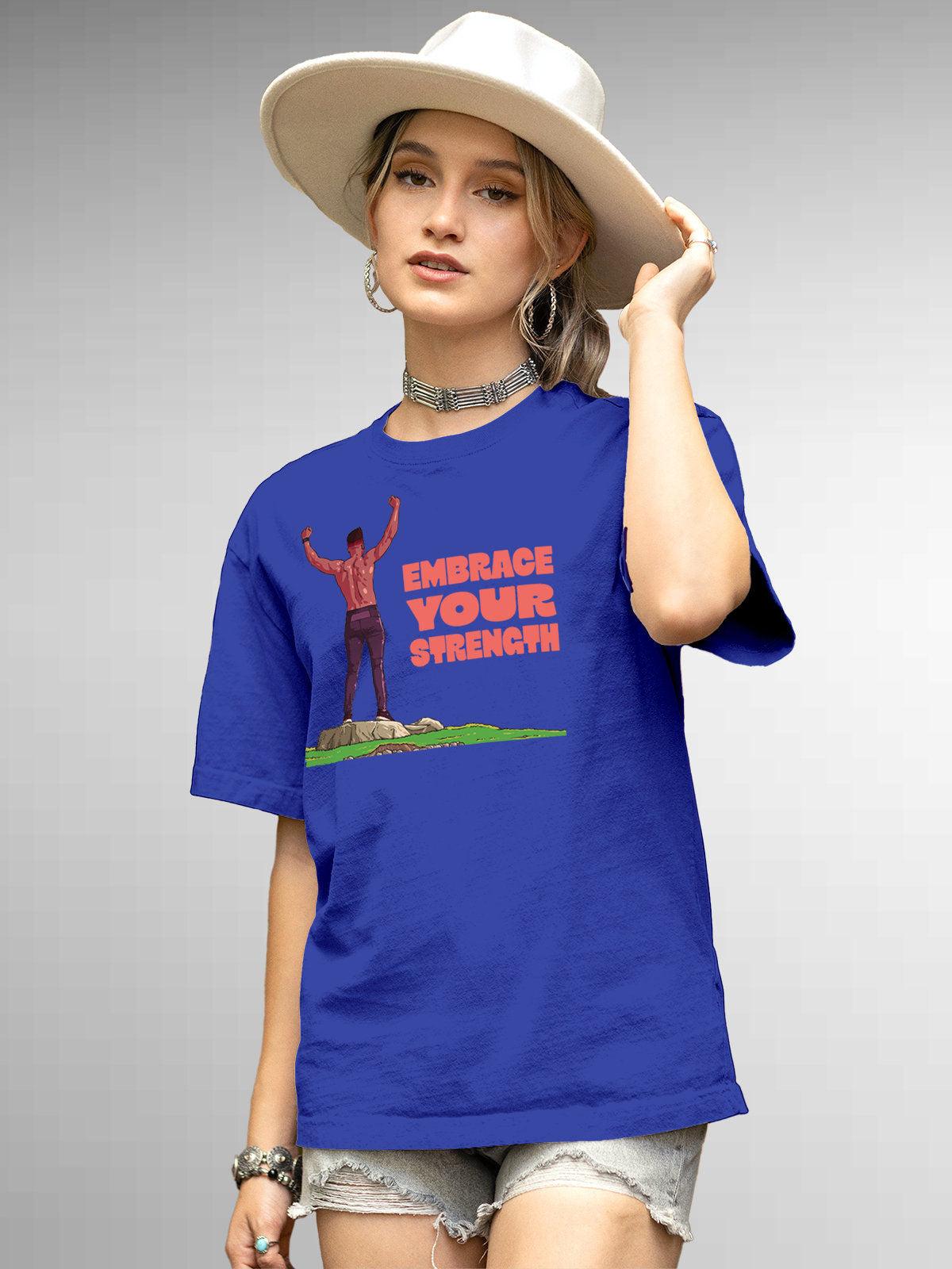Model wearing Women's Blue Round Neck T-shirt with 'Embrace Your Strength' design, offering effortless style and premium comfort