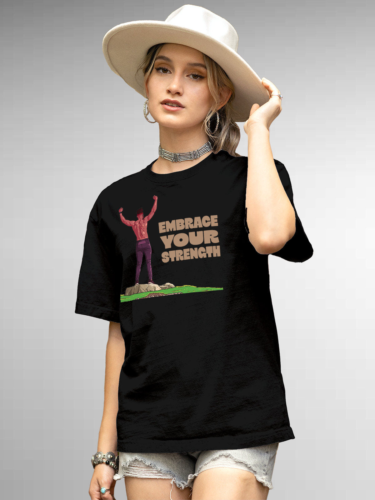 Model wearing Women's Black Round Neck T-shirt with 'Embrace Your Strength' design, offering effortless style and premium comfort
