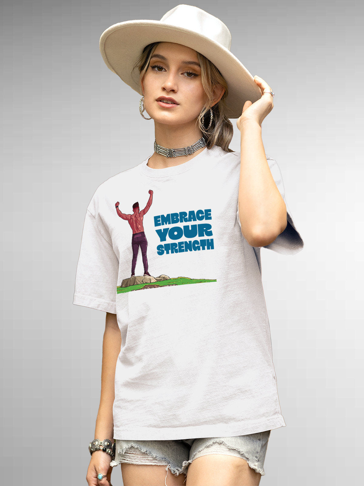 Model wearing Women's White Round Neck T-shirt with 'Embrace Your Strength' design, offering effortless style and premium comfort