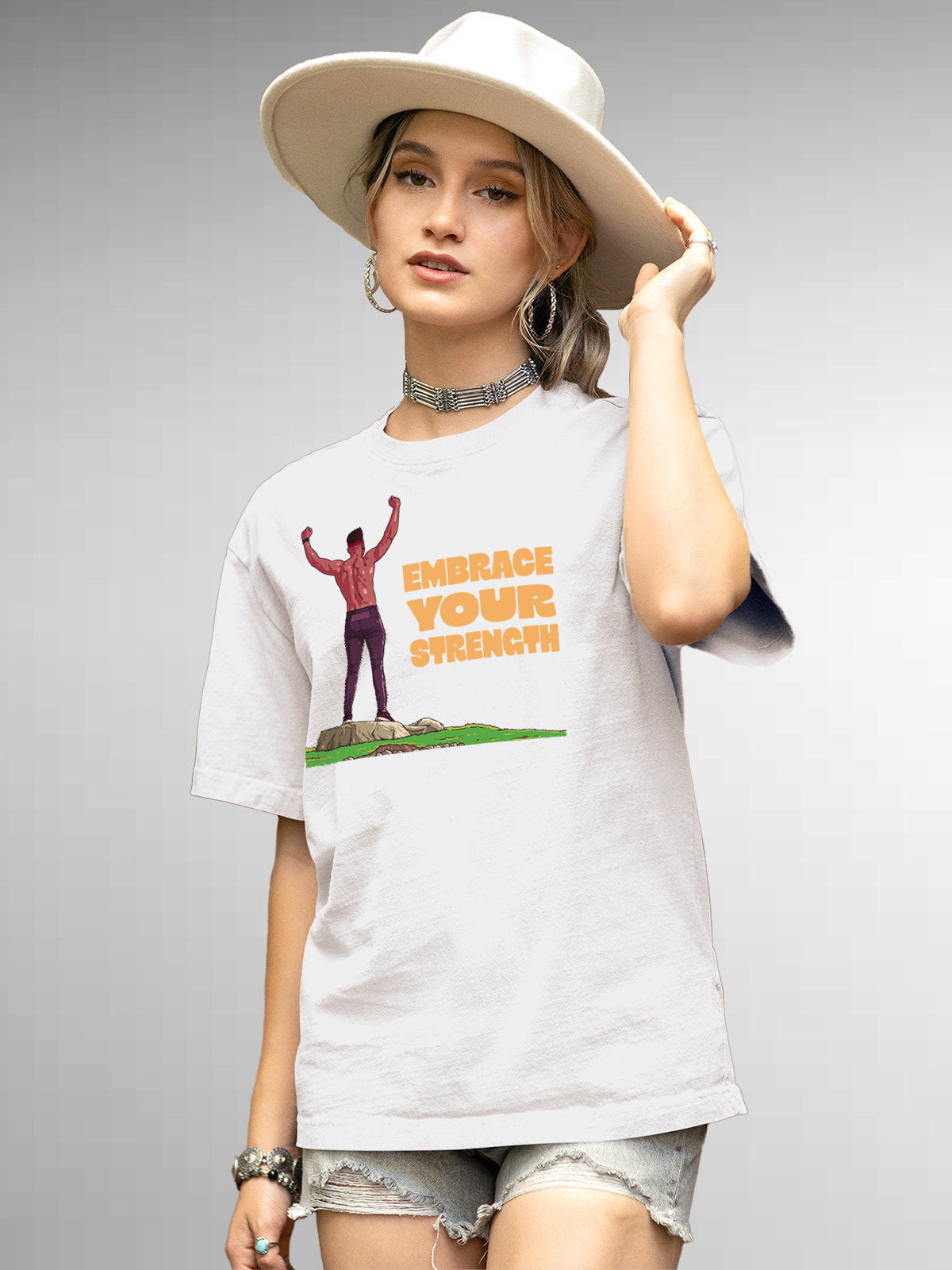 Model wearing Women's White Round Neck T-shirt with 'Embrace Your Strength' design, offering effortless style and premium comfort