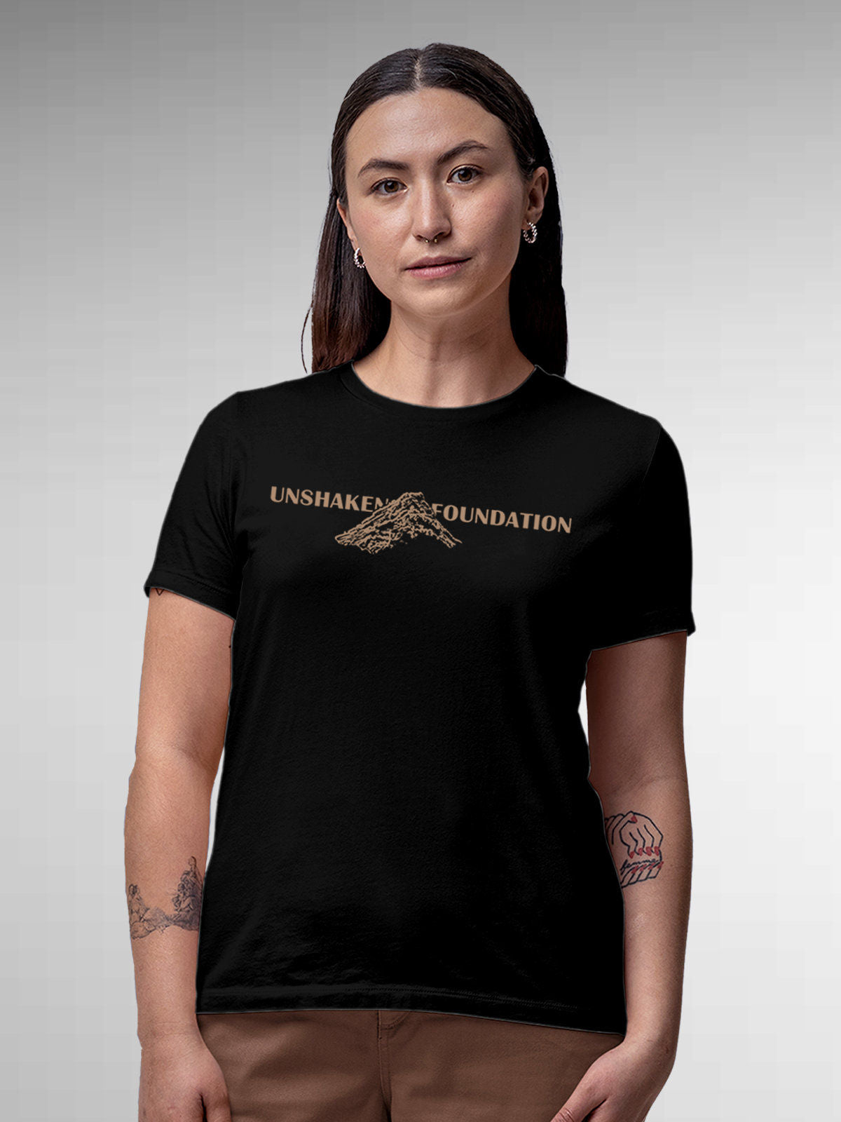Model wearing Women's Black Round Neck T-shirt with 'Unshaken Foundation' design, offering effortless style and premium comfort