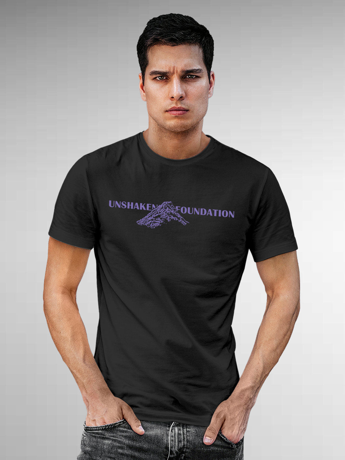 Model wearing Men's Dark Grey Round Neck T-shirt with 'Unshaken Foundation' design, offering effortless style and premium comfort