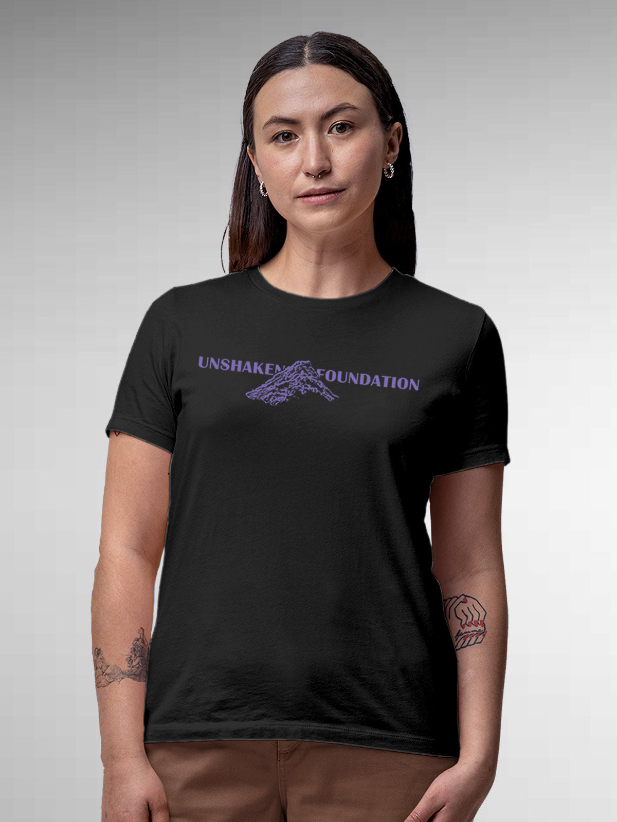 Model wearing Women's Dark Grey Round Neck T-shirt with 'Unshaken Foundation' design, offering effortless style and premium comfort