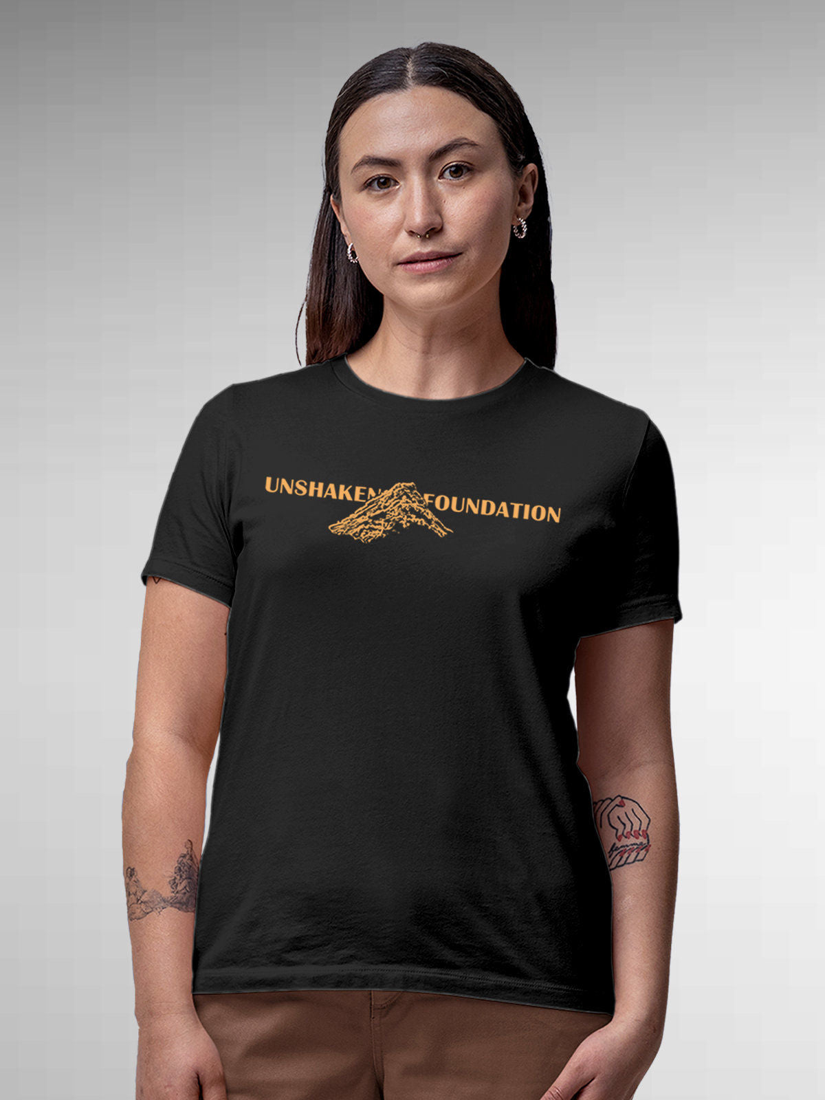 Model wearing Women's Dark Grey Round Neck T-shirt with 'Unshaken Foundation' design, offering effortless style and premium comfort