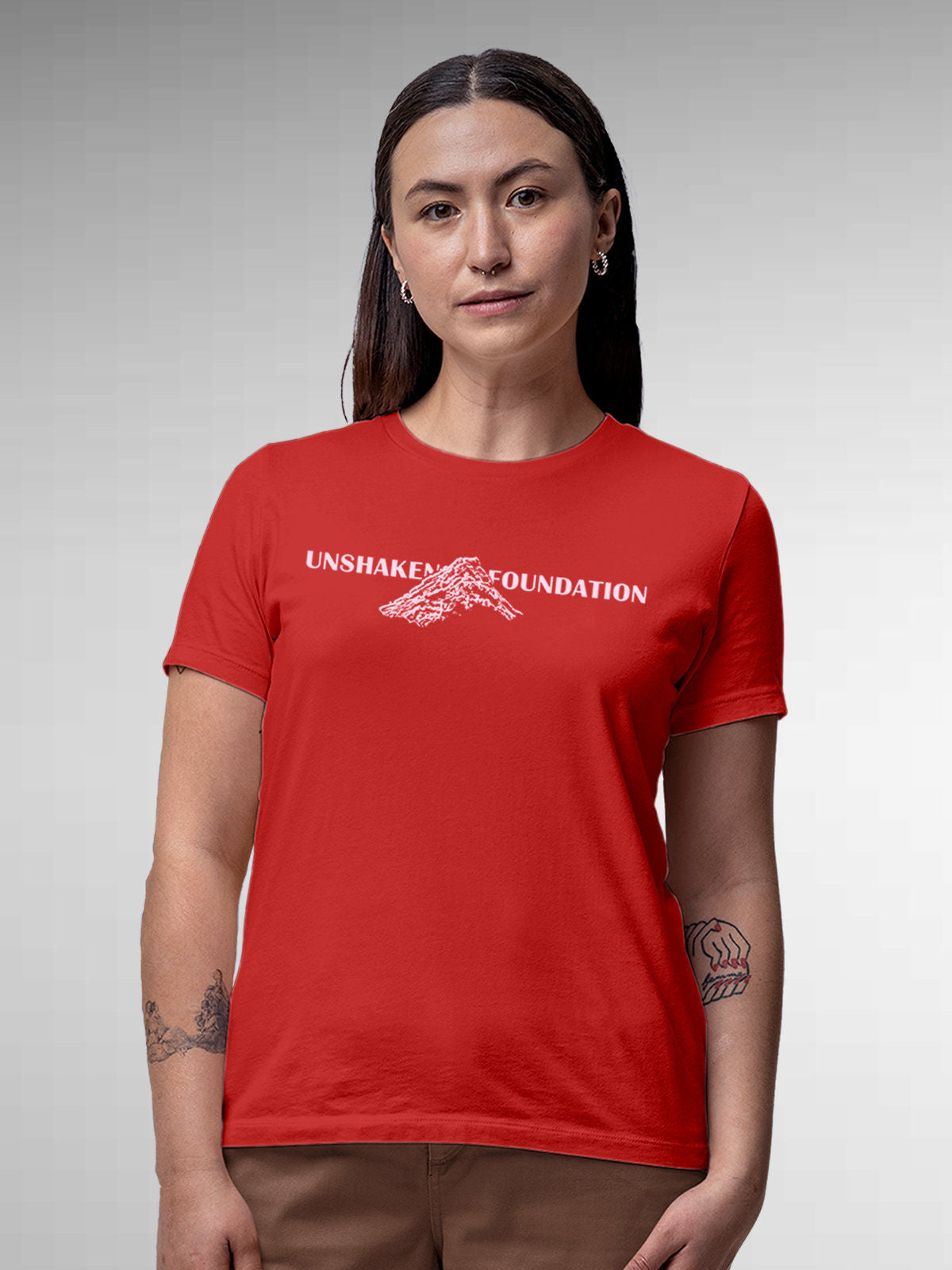 Model wearing Women's Red Round Neck T-shirt with 'Unshaken Foundation' design, offering effortless style and premium comfort