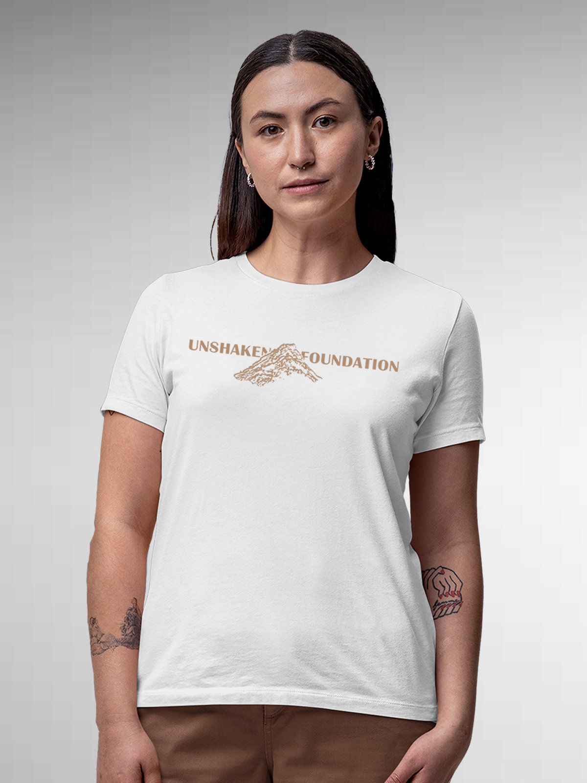 Model wearing Women's White Round Neck T-shirt with 'Unshaken Foundation' design, offering effortless style and premium comfort
