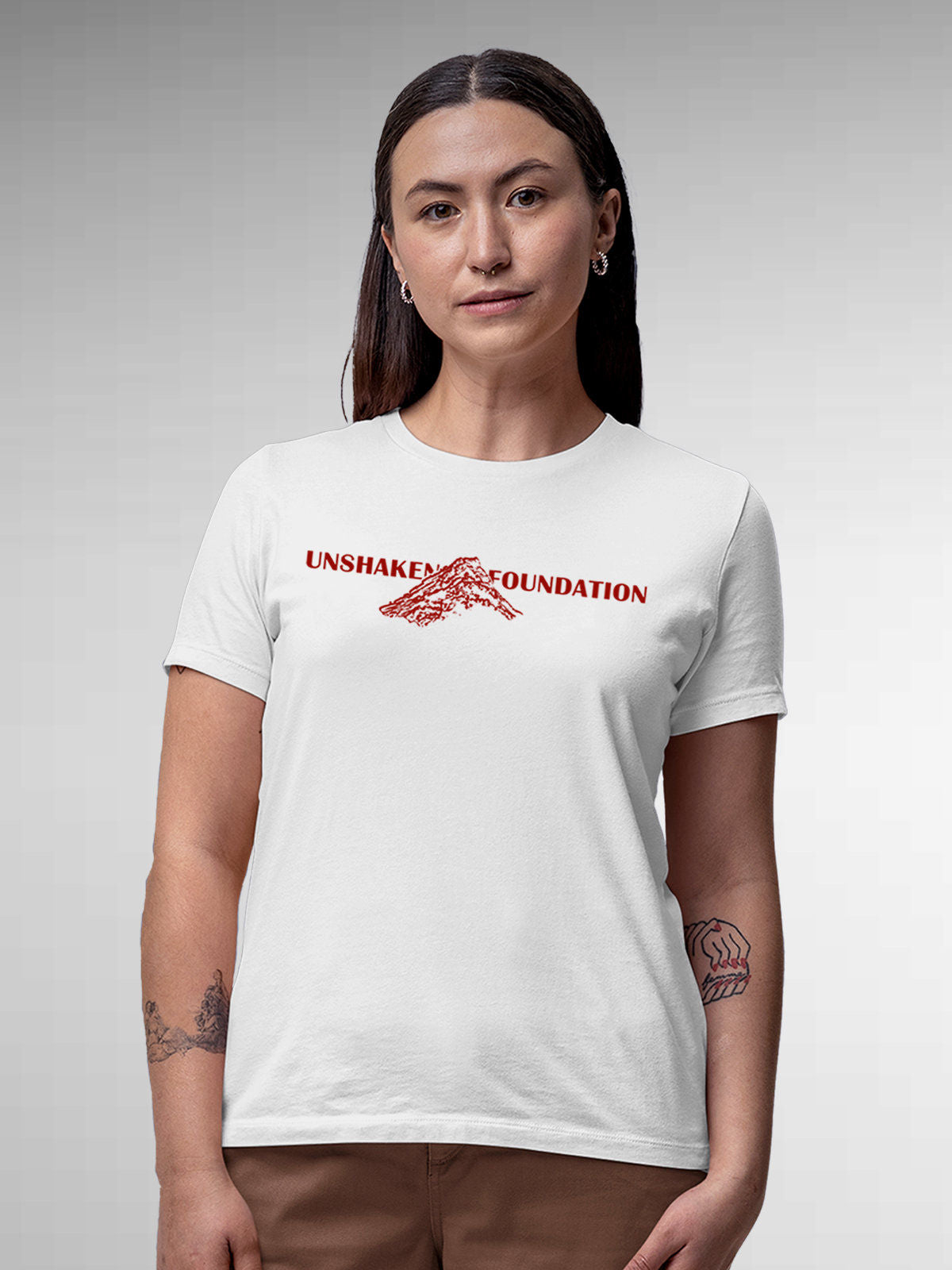 Model wearing Women's White Round Neck T-shirt with 'Unshaken Foundation' design, offering effortless style and premium comfort