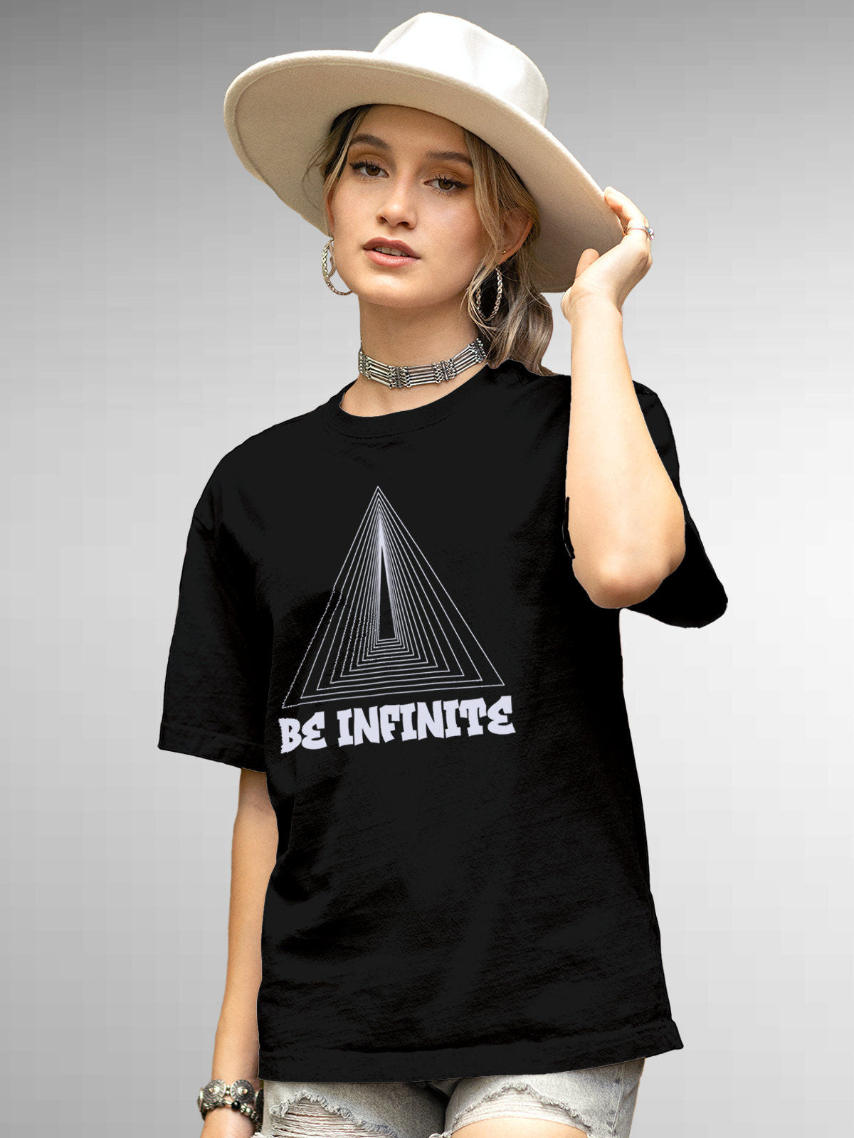 Model wearing Women's Black Round Neck T-shirt with 'Be Infinite' design, offering effortless style and premium comfort