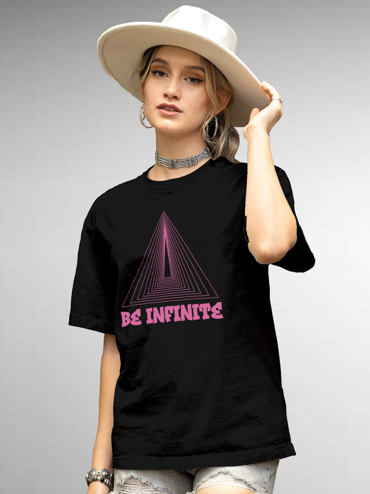 Model wearing Women's Black Round Neck T-shirt with 'Be Infinite' design, offering effortless style and premium comfort