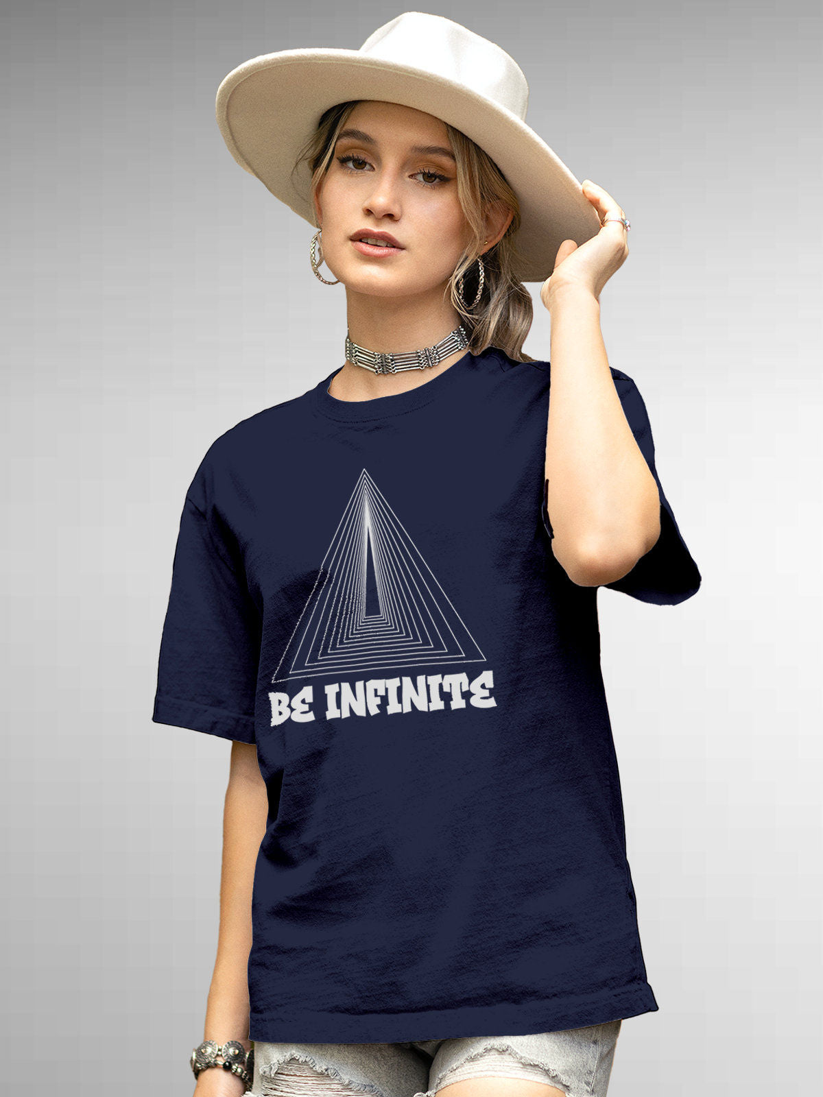 Model wearing Women's Navy Blue Round Neck T-shirt with 'Be Infinite' design, offering effortless style and premium comfort