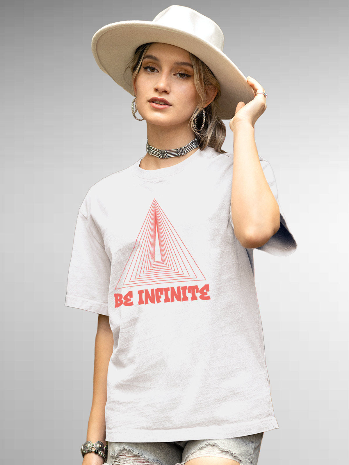 Model wearing Women's White Round Neck T-shirt with 'Be Infinite' design, offering effortless style and premium comfort