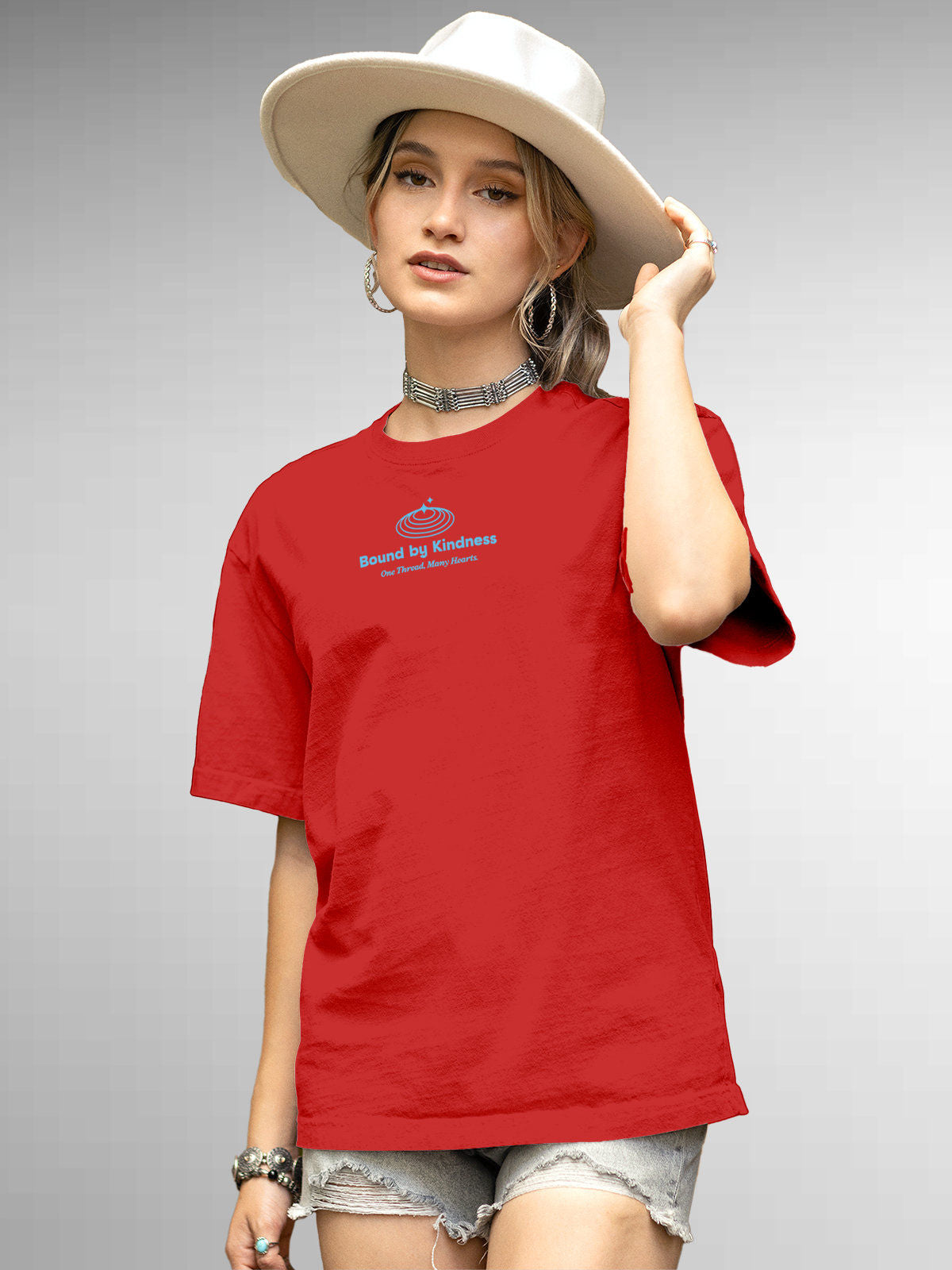 Model wearing Women's Red Round Neck T-shirt with 'Bound By Kindness' design, offering effortless style and premium comfort