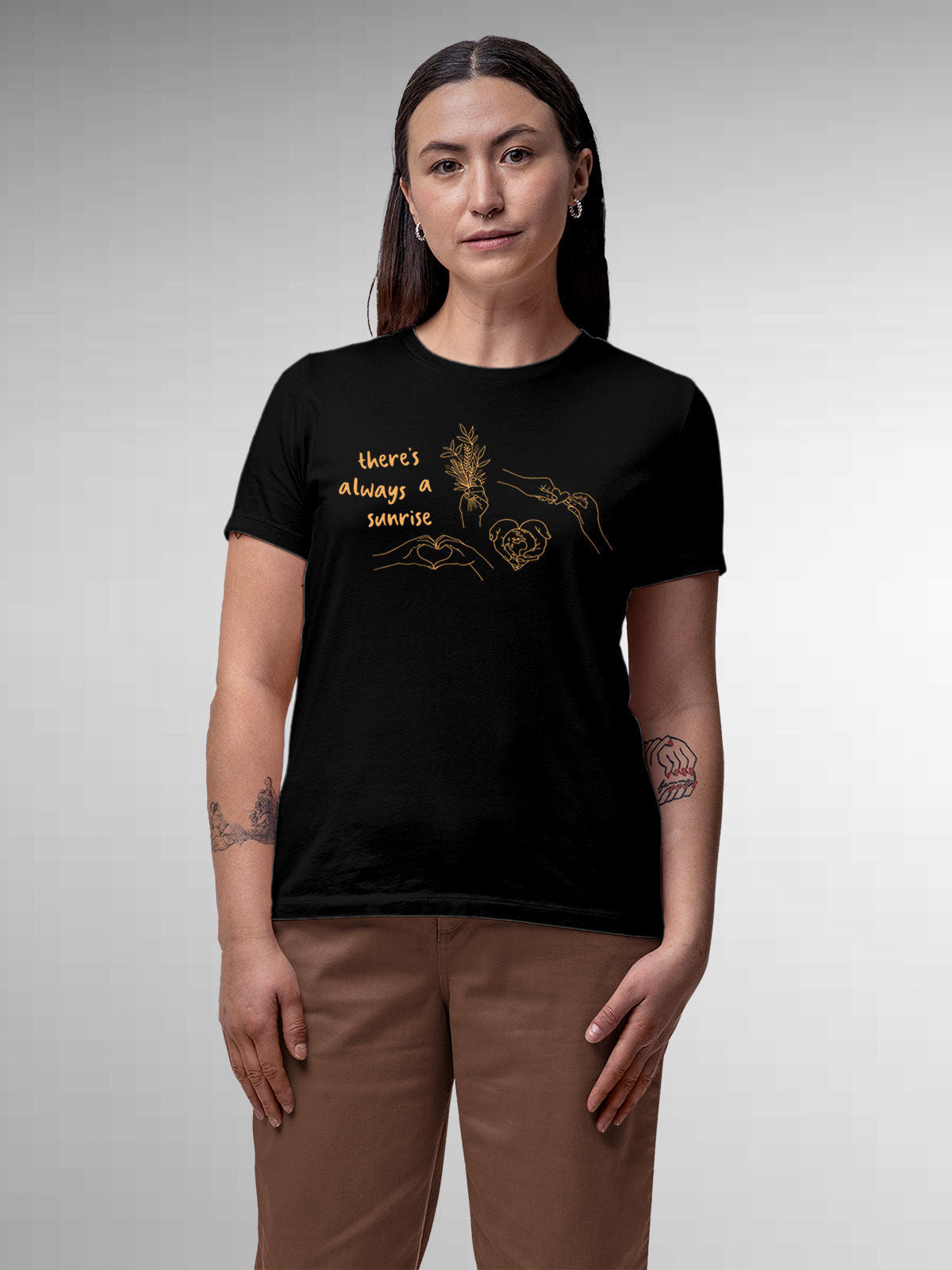 Model wearing Women's Black Round Neck T-shirt with 'There's Always a Sunrise' design, offering effortless style and premium comfort