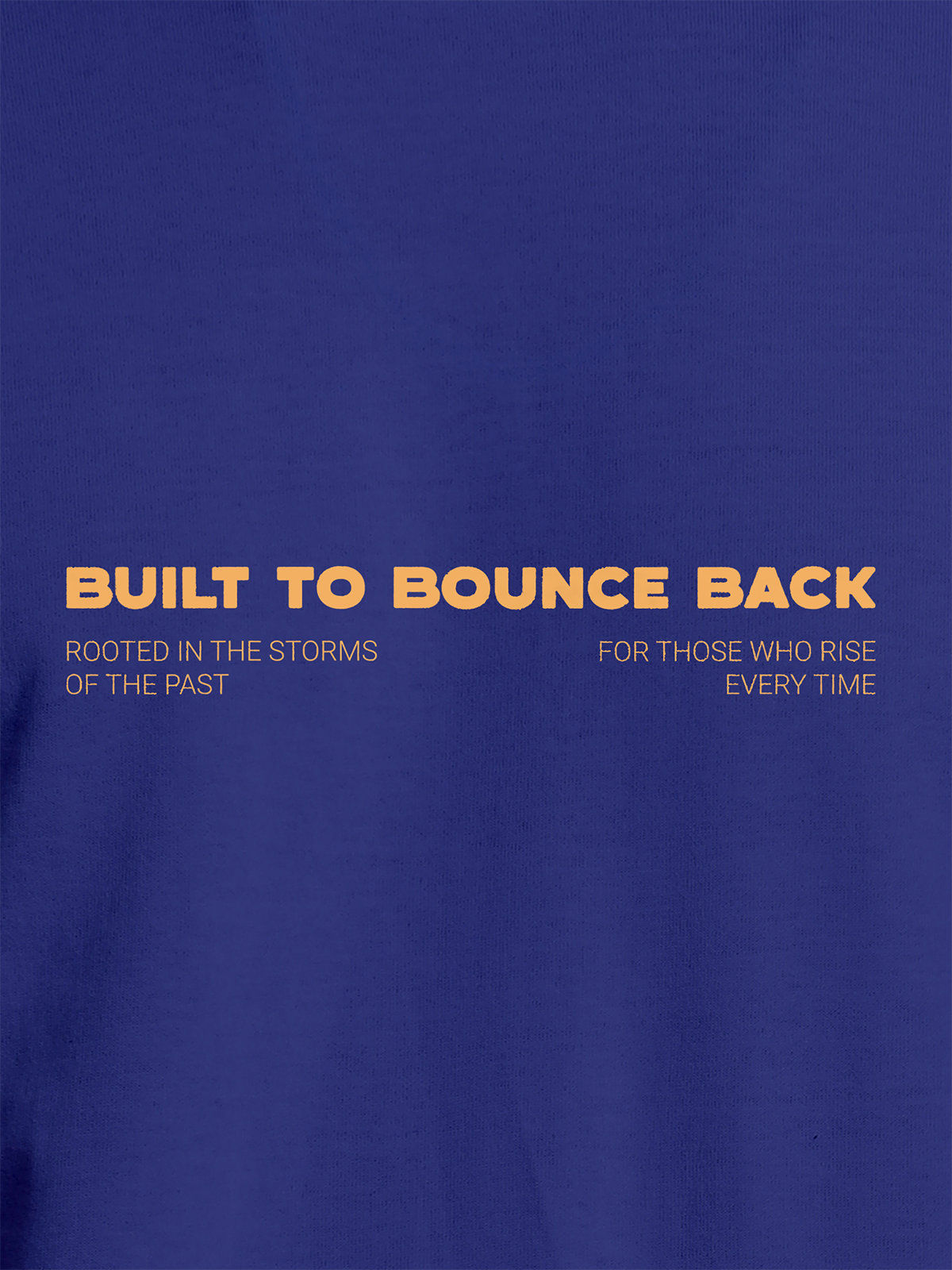 Close up of 'Built To Bounce Back' design on Men's Blue Round Neck T-shirt, highlighting intricate details and vibrant print.