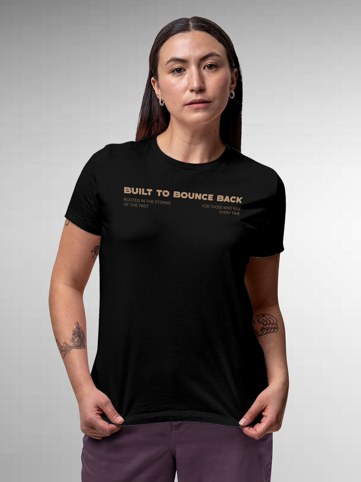 Model wearing Women's Black Round Neck T-shirt with 'Built To Bounce Back' design, offering effortless style and premium comfort