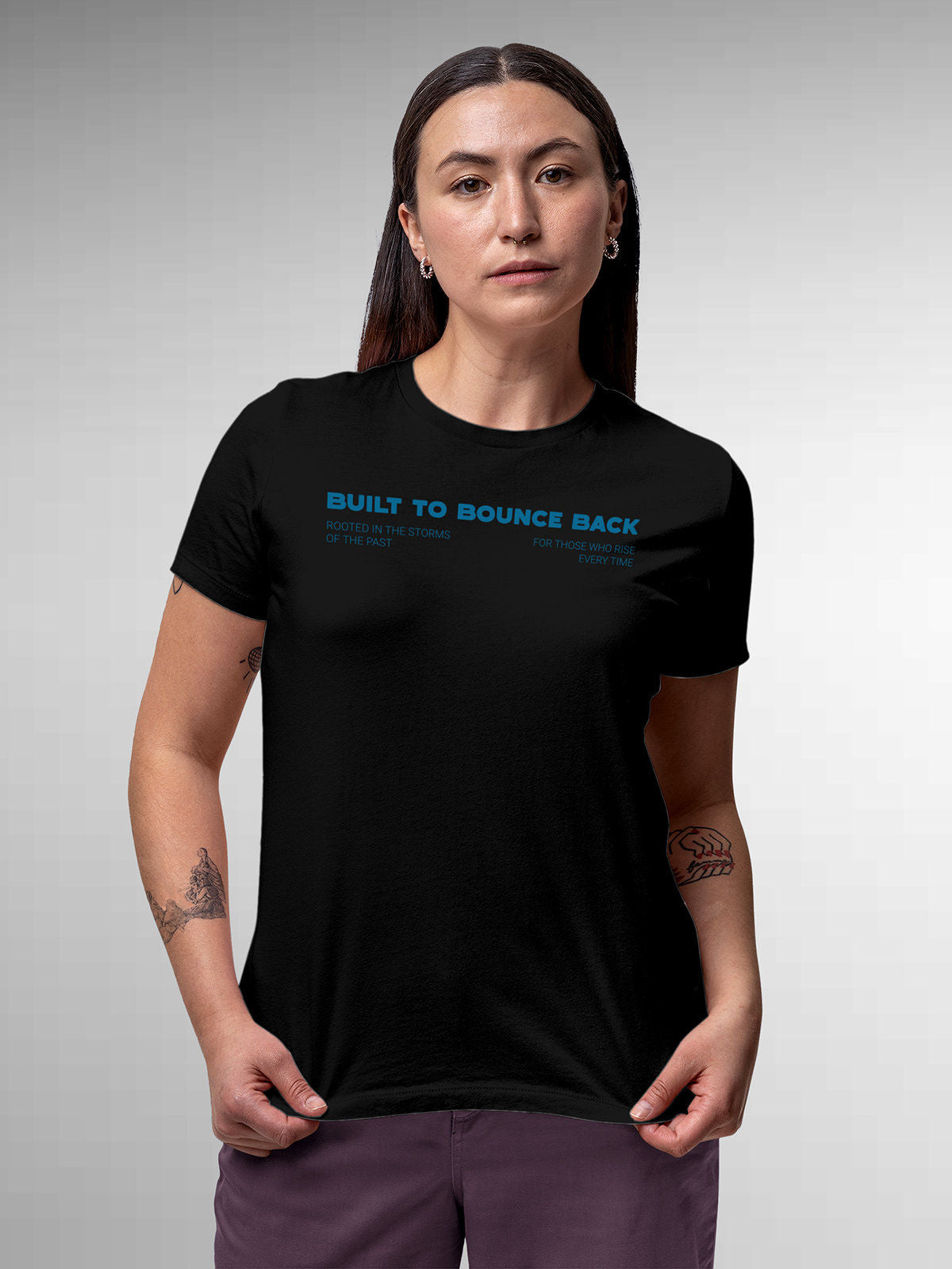 Model wearing Women's Black Round Neck T-shirt with 'Built To Bounce Back' design, offering effortless style and premium comfort