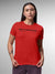 Model wearing Women's Red Round Neck T-shirt with 'Built To Bounce Back' design, offering effortless style and premium comfort