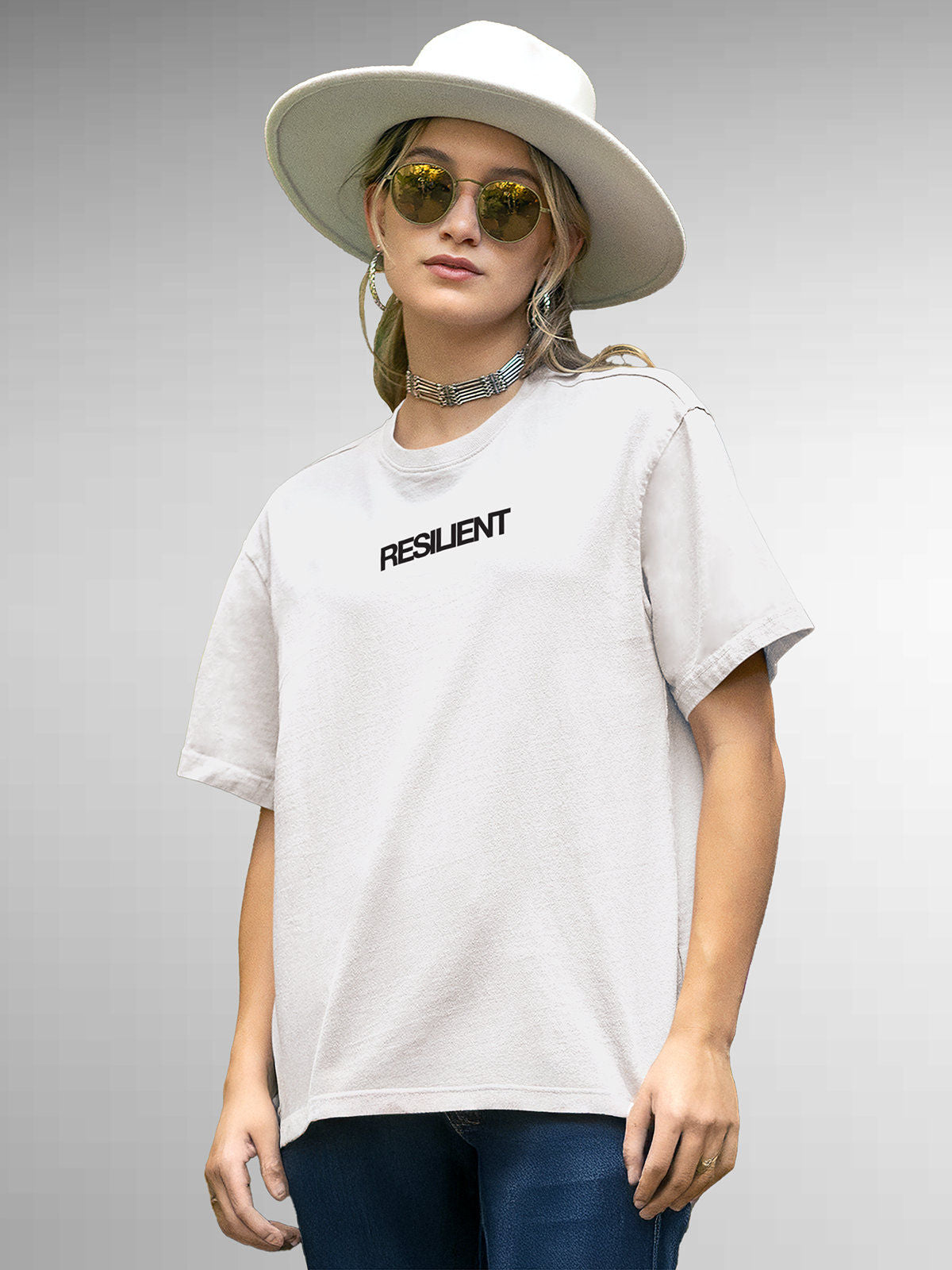 Model wearing Women's White Round Neck T-shirt with 'Resilient' design, offering effortless style and premium comfort