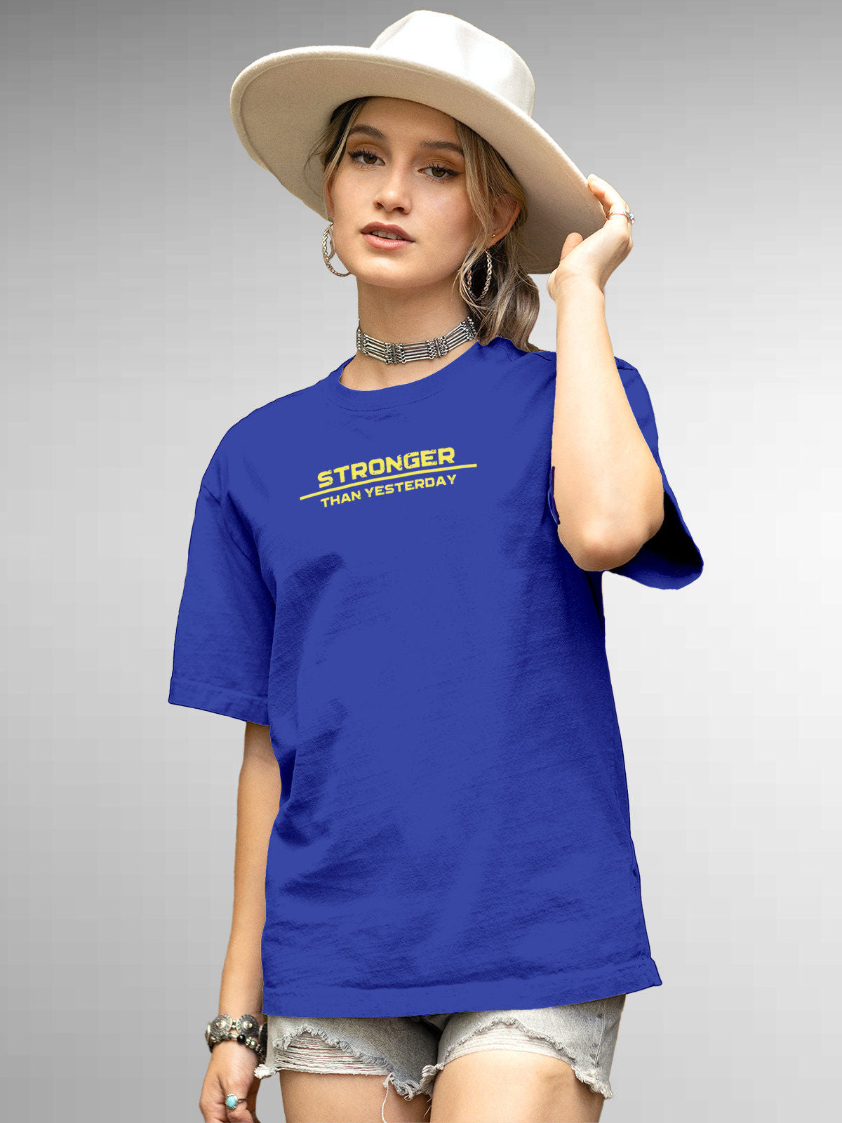 Model wearing Women's Blue Round Neck T-shirt with 'Stronger Than Yesterday' design, offering effortless style and premium comfort