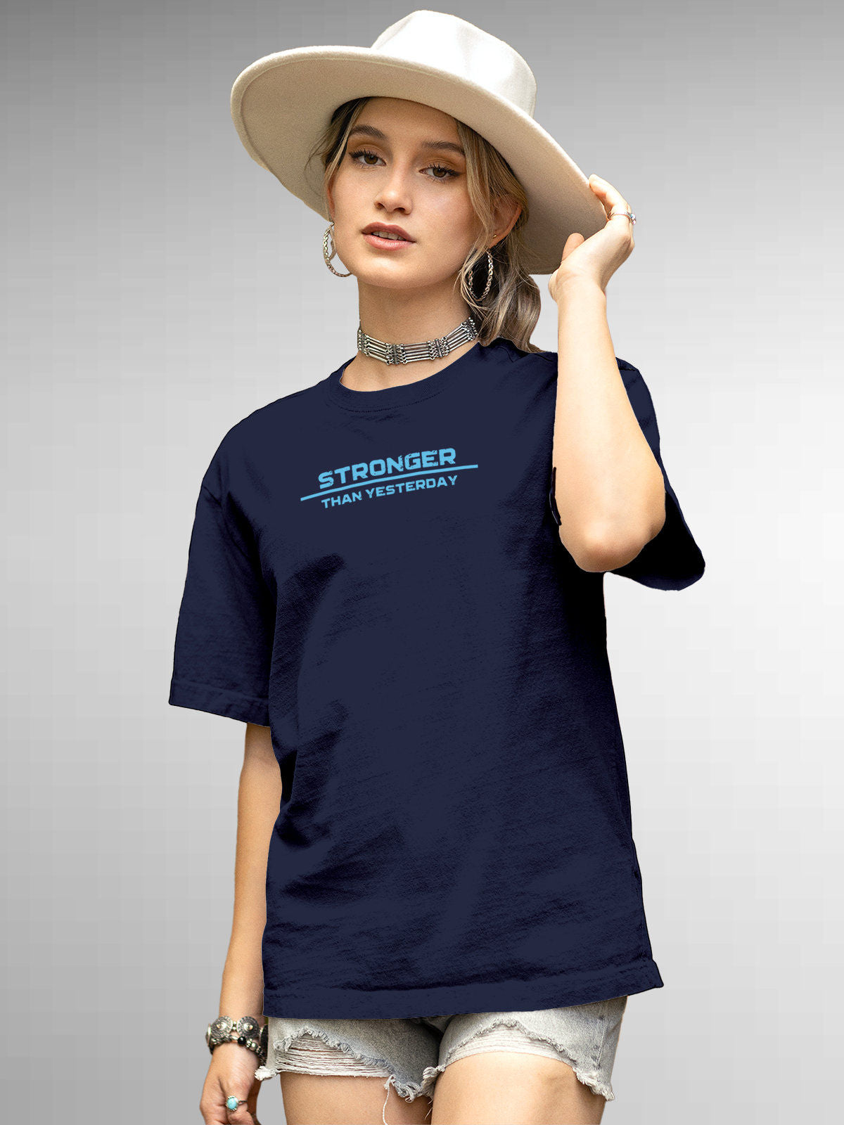 Model wearing Women's Navy Blue Round Neck T-shirt with 'Stronger Than Yesterday' design, offering effortless style and premium comfort