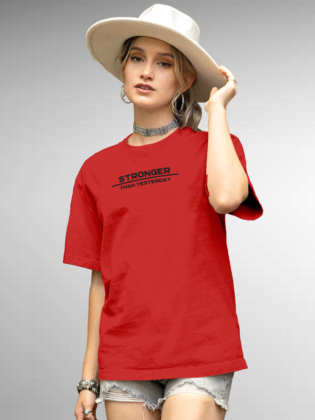 Model wearing Women's Red Round Neck T-shirt with 'Stronger Than Yesterday' design, offering effortless style and premium comfort