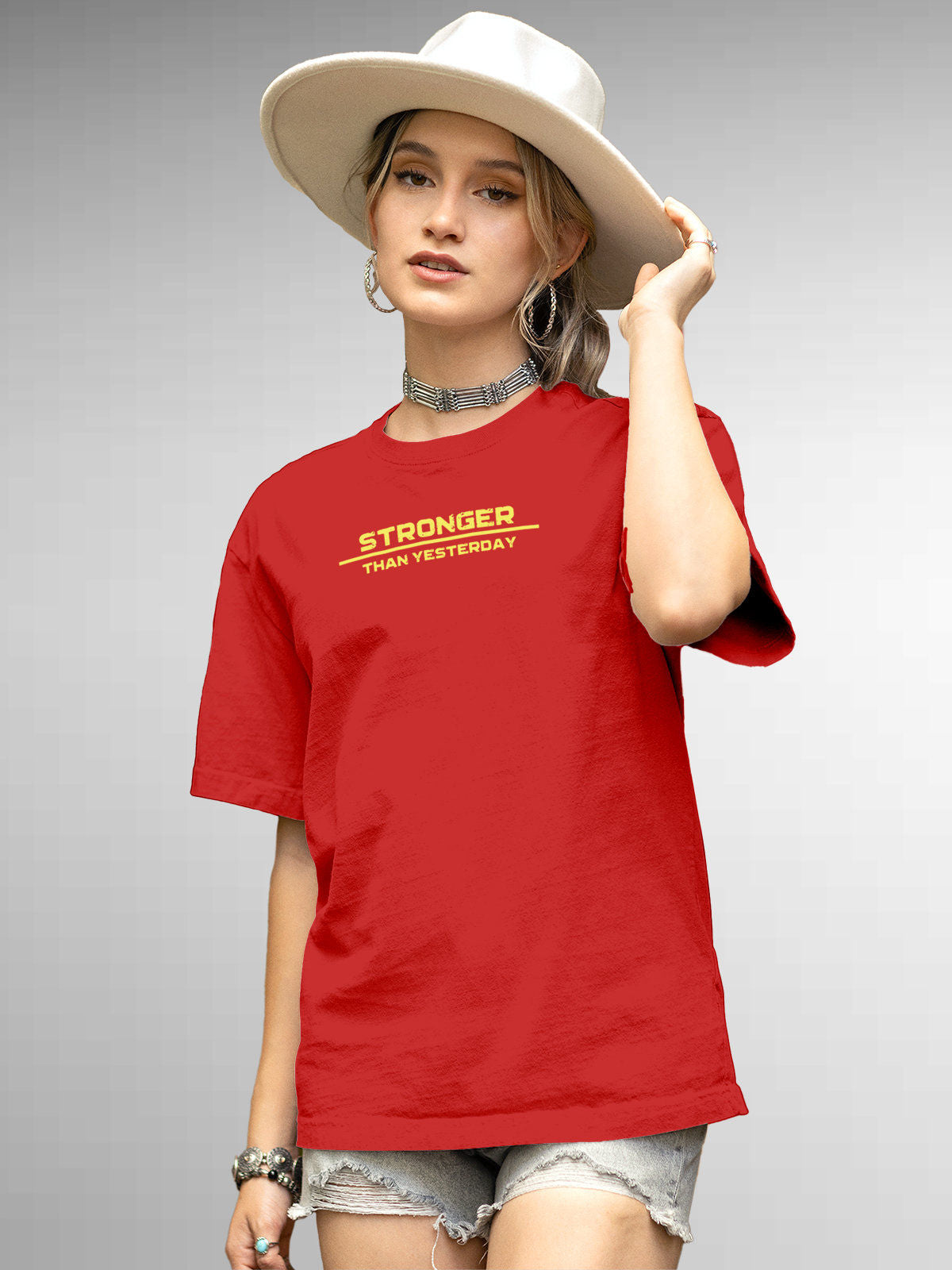 Model wearing Women's Red Round Neck T-shirt with 'Stronger Than Yesterday' design, offering effortless style and premium comfort