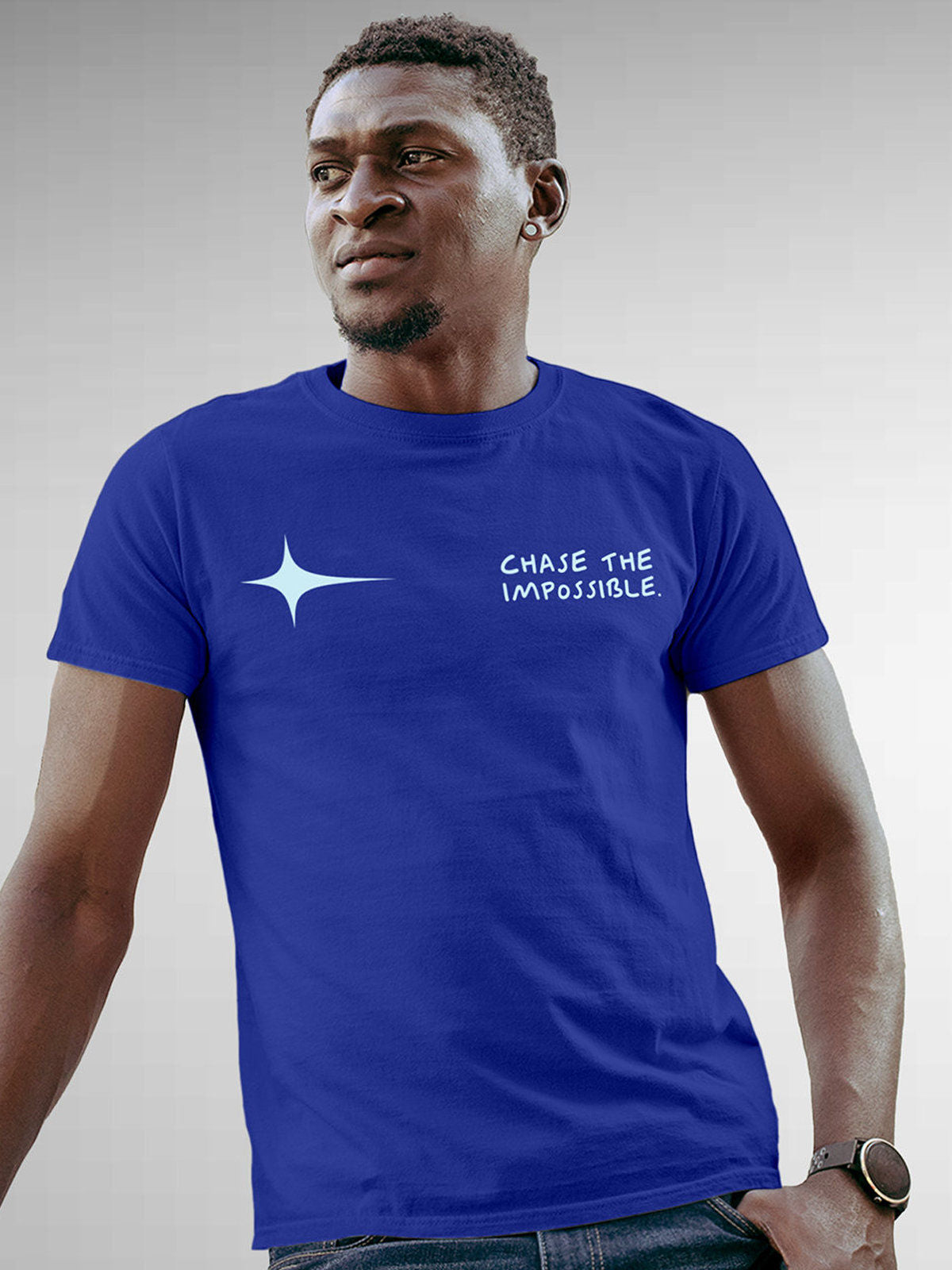 Model wearing Men's Blue Round Neck T-shirt with 'Chase The Impossible' design, offering effortless style and premium comfort