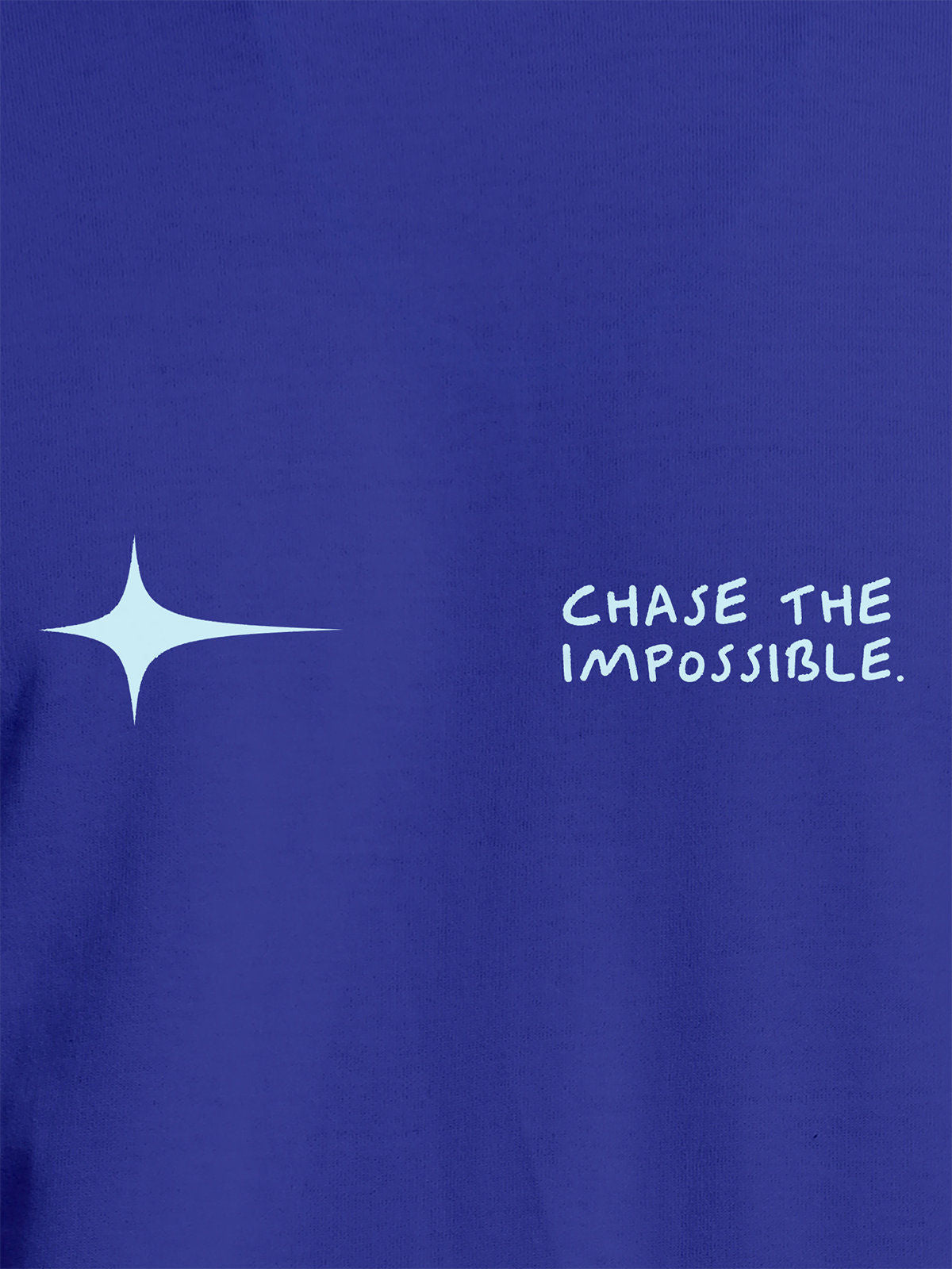 Close up of 'Chase The Impossible' design on Women's Blue Round Neck T-shirt, highlighting intricate details and vibrant print.