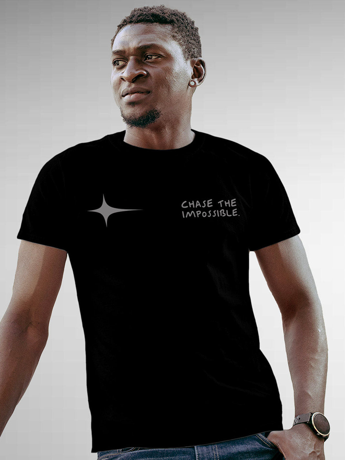 Model wearing Men's Black Round Neck T-shirt with 'Chase The Impossible' design, offering effortless style and premium comfort