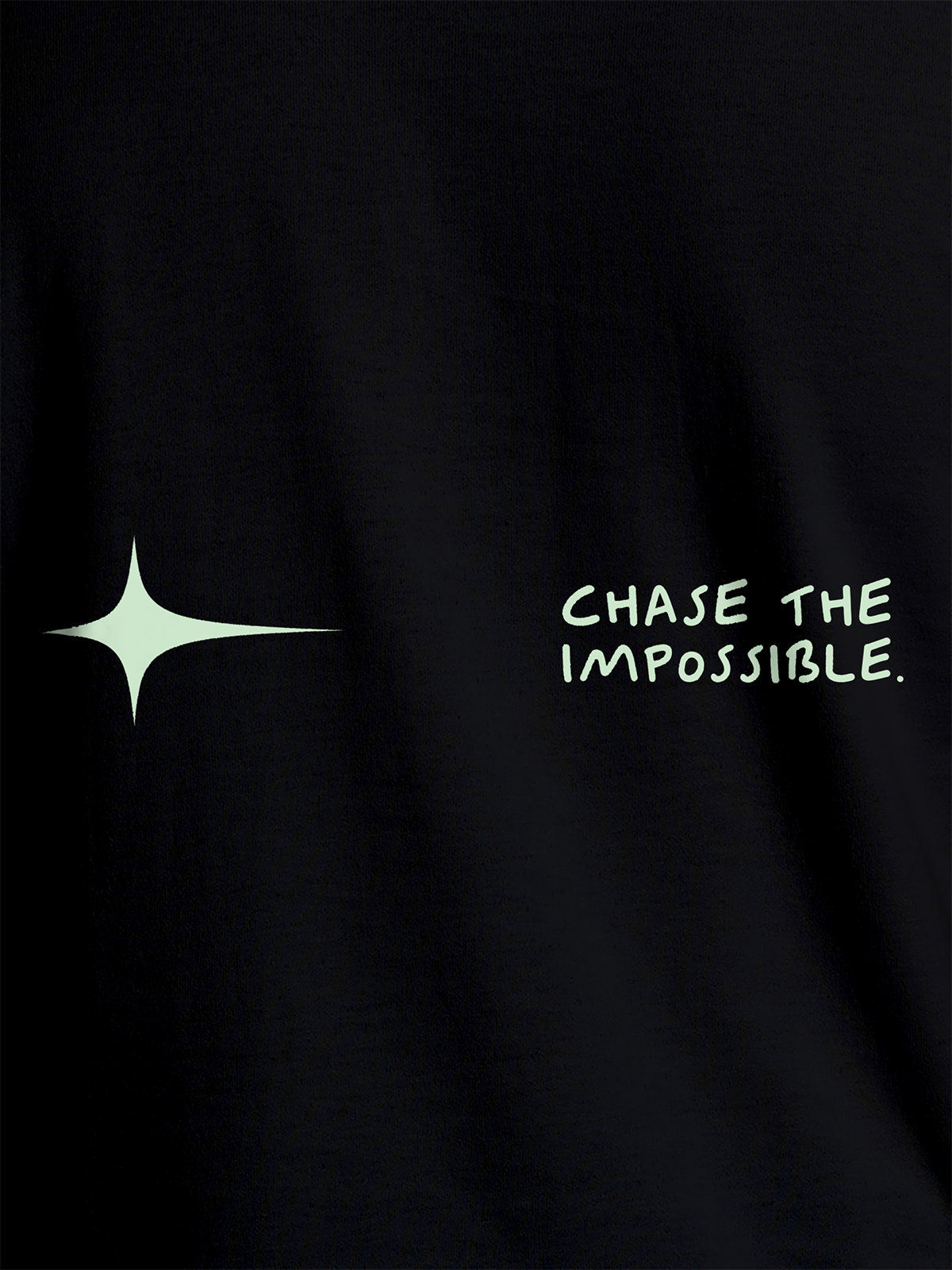 Close up of 'Chase The Impossible' design on Men's Black Round Neck T-shirt, highlighting intricate details and vibrant print.