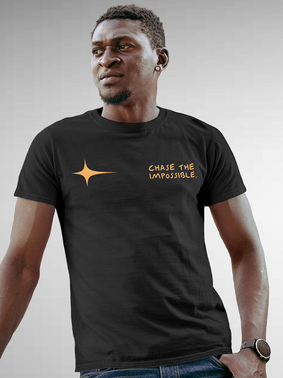 Model wearing Men's Dark Grey Round Neck T-shirt with 'Chase The Impossible' design, offering effortless style and premium comfort