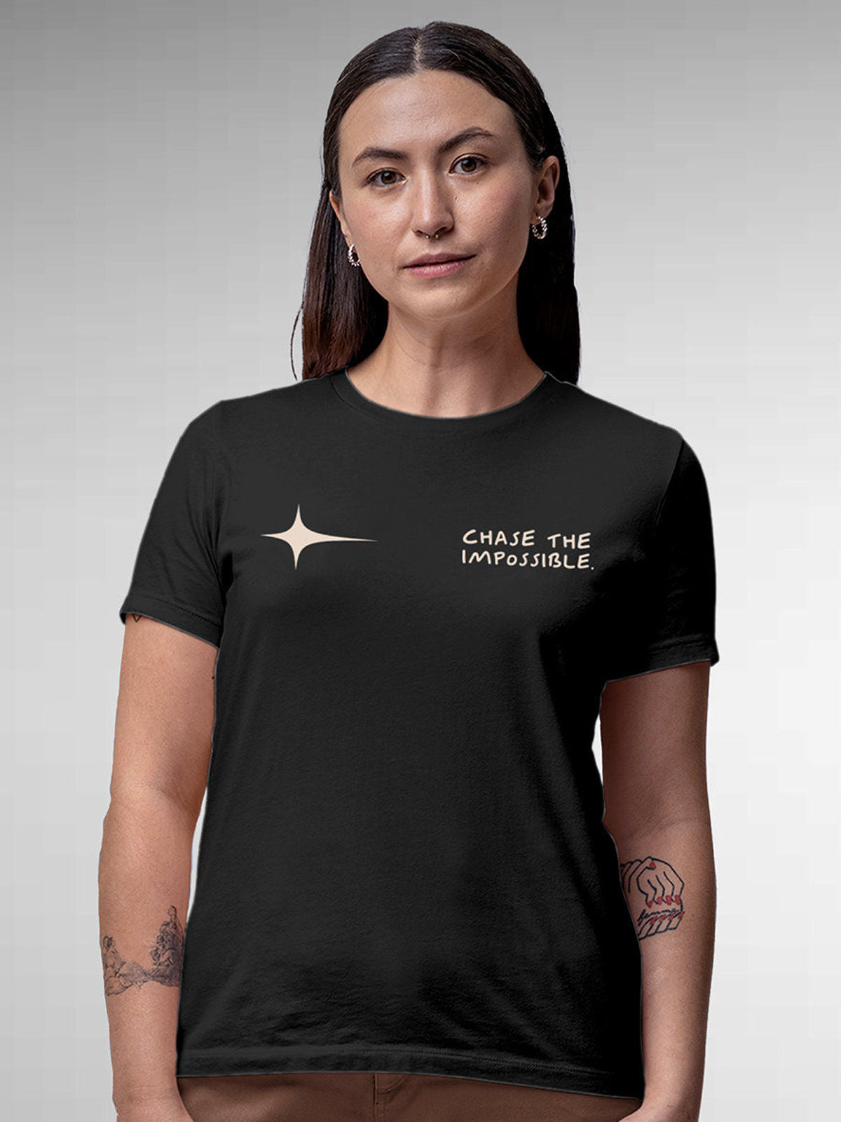 Model wearing Women's Dark Grey Round Neck T-shirt with 'Chase The Impossible' design, offering effortless style and premium comfort