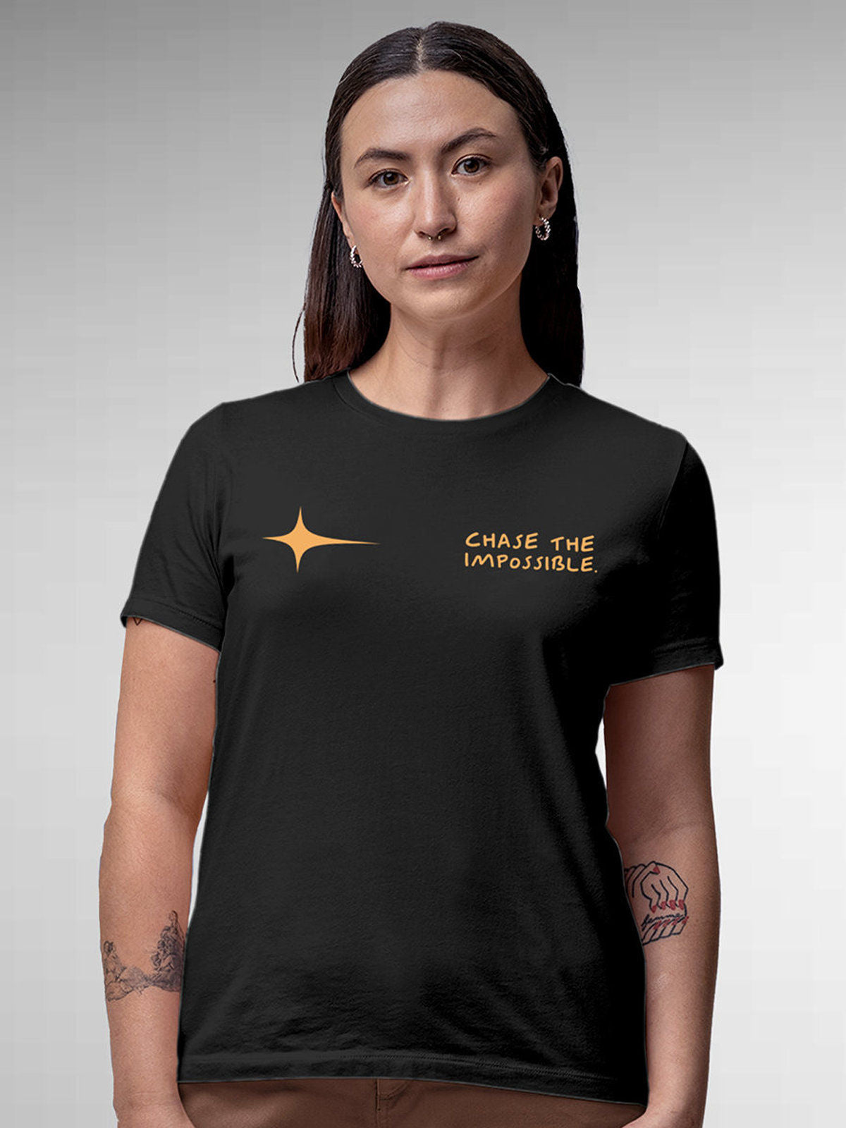 Model wearing Women's Dark Grey Round Neck T-shirt with 'Chase The Impossible' design, offering effortless style and premium comfort