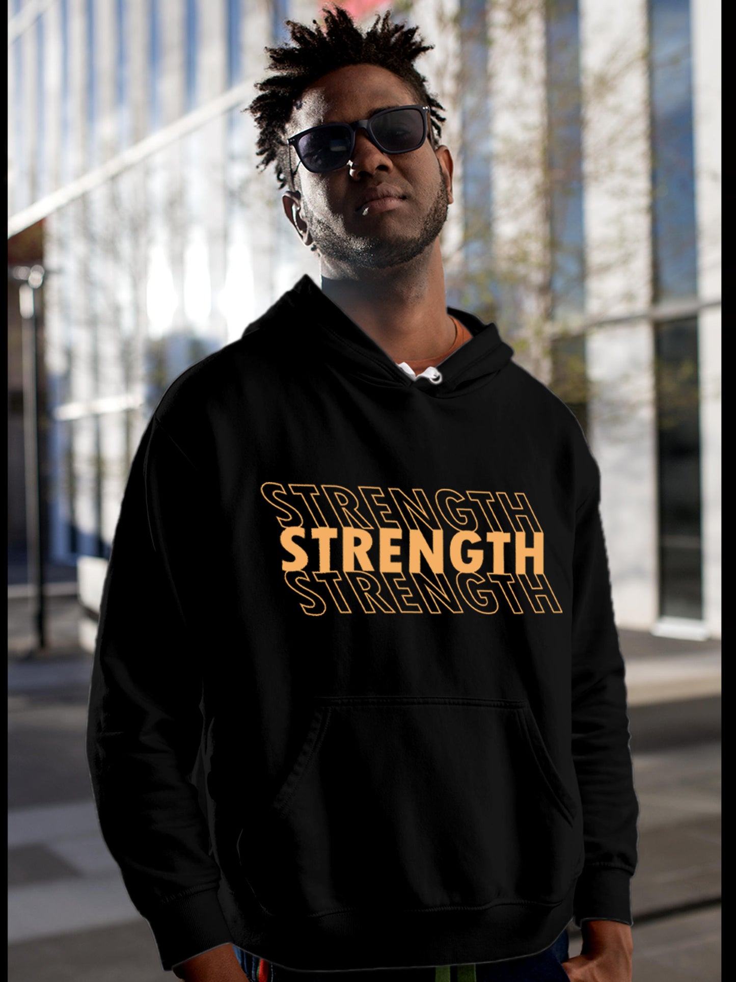 Model wearing Men's Black Hoodie Sweatshirt with 'Strength' design, offering effortless style and premium comfort