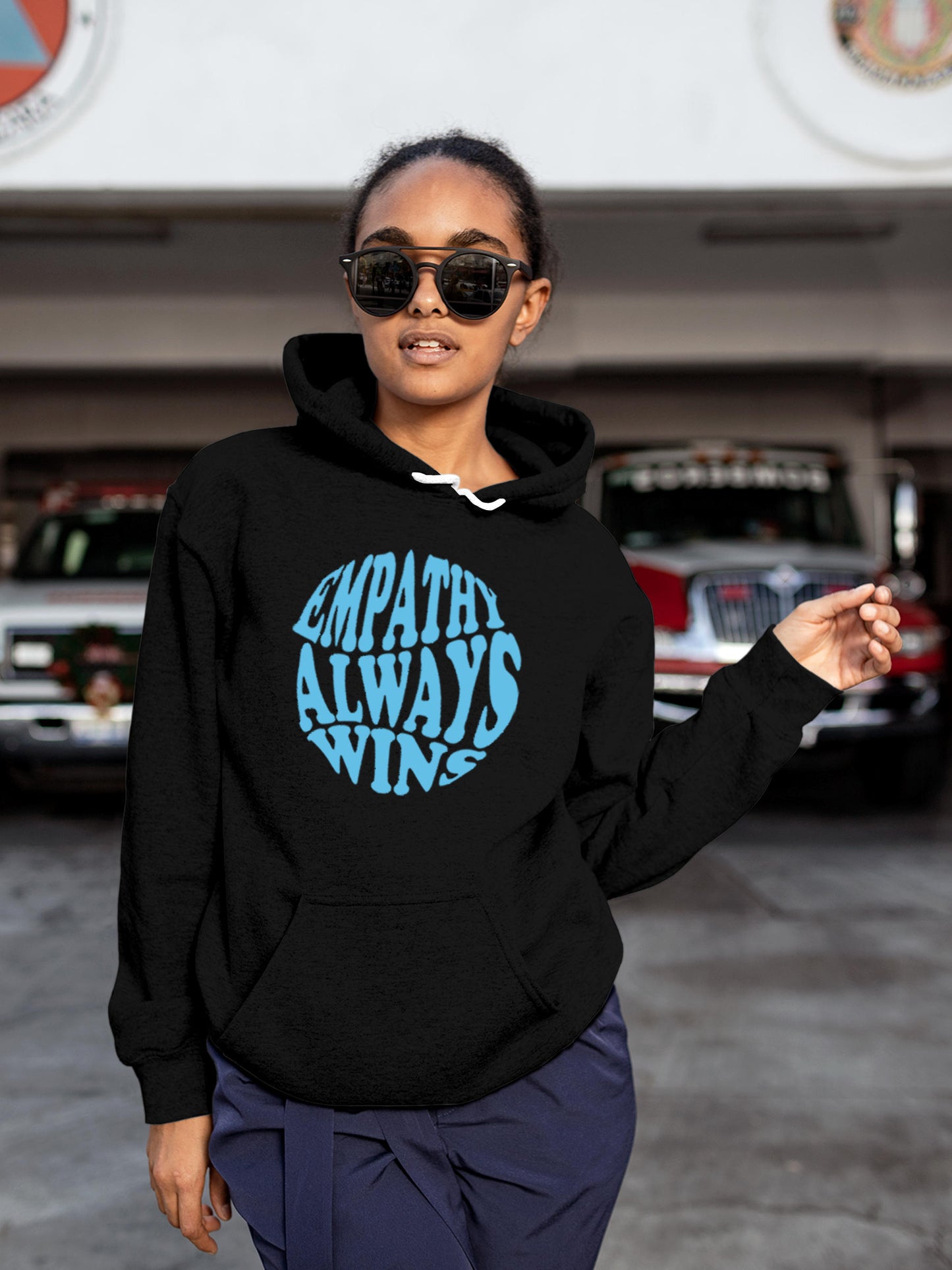Model wearing Women's Black Hoodie Sweatshirt with 'Empathy Always Wins' design, offering effortless style and premium comfort