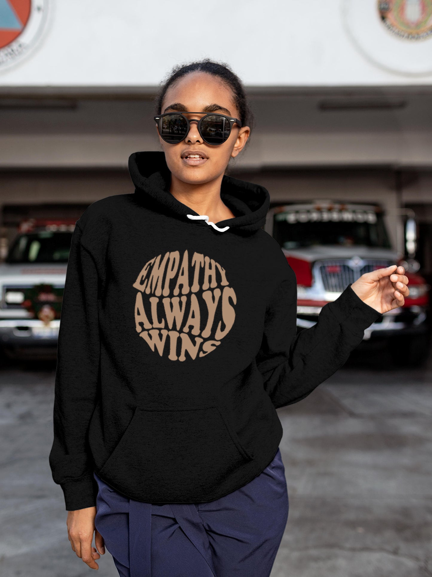 Model wearing Women's Black Hoodie Sweatshirt with 'Empathy Always Wins' design, offering effortless style and premium comfort