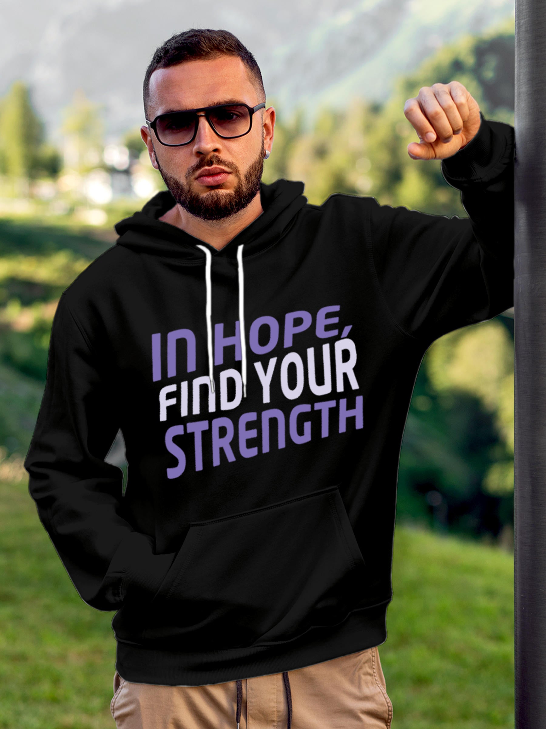 Model wearing Men's Black Hoodie Sweatshirt with 'In Hope, Find Your Strength' design, offering effortless style and premium comfort