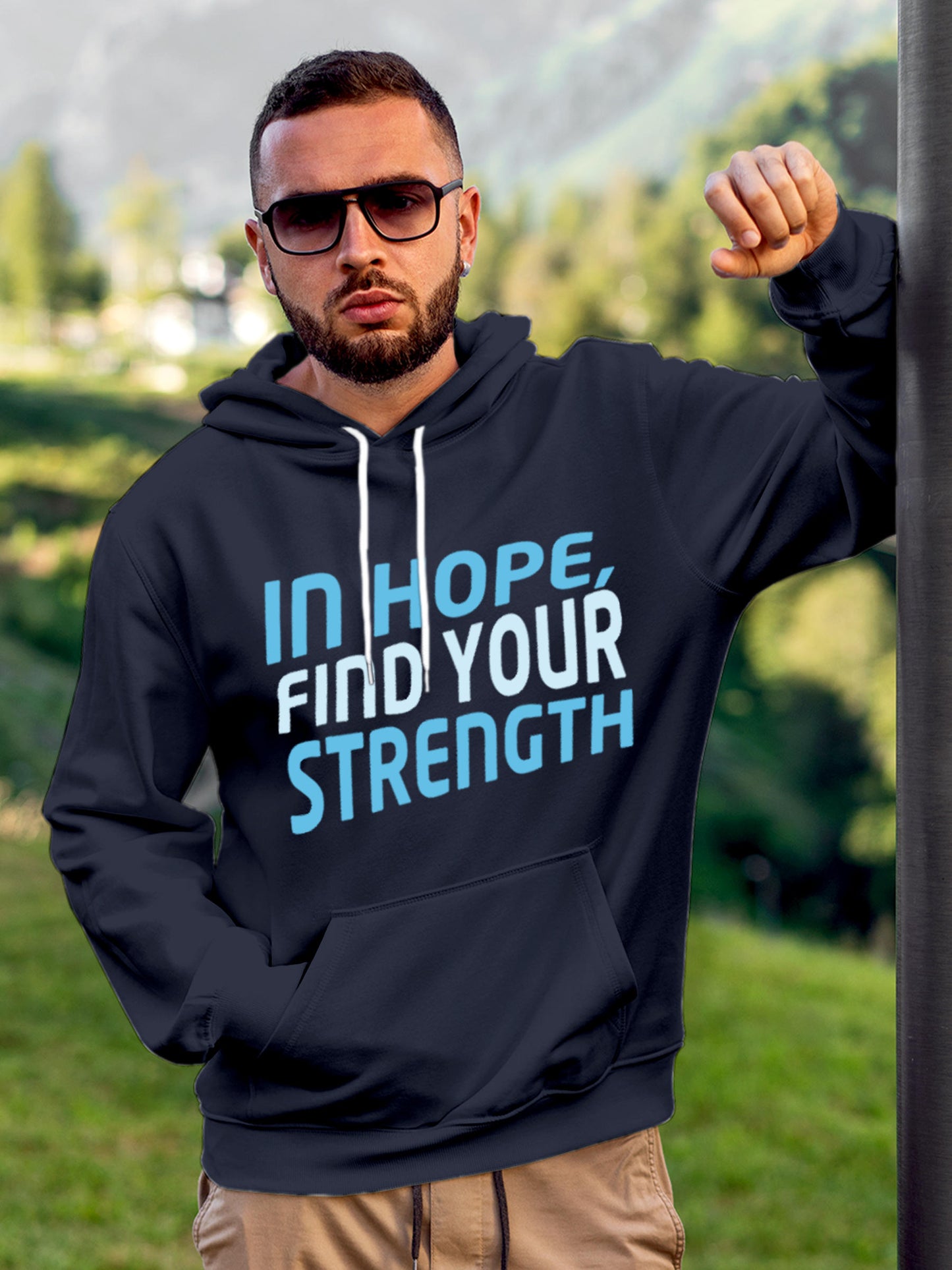 Model wearing Men's Navy Blue Hoodie Sweatshirt with 'In Hope, Find Your Strength' design, offering effortless style and premium comfort