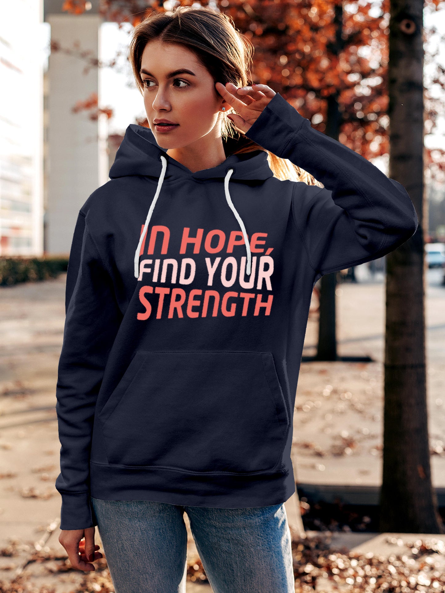 Model wearing Women's Navy Blue Hoodie Sweatshirt with 'In Hope, Find Your Strength' design, offering effortless style and premium comfort
