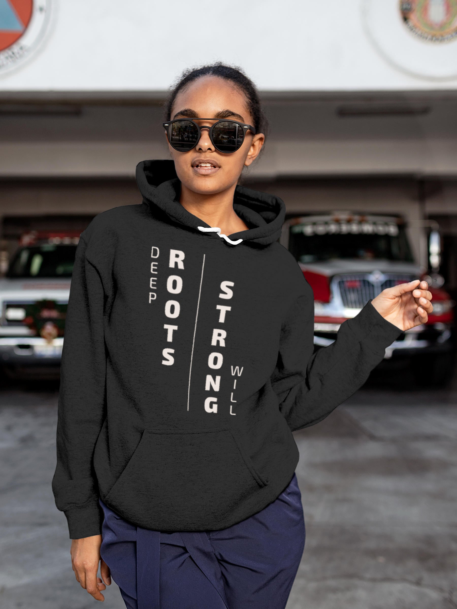 Model wearing Women's Dark Grey Hoodie Sweatshirt with 'Deep Roots Strong Will' design, offering effortless style and premium comfort