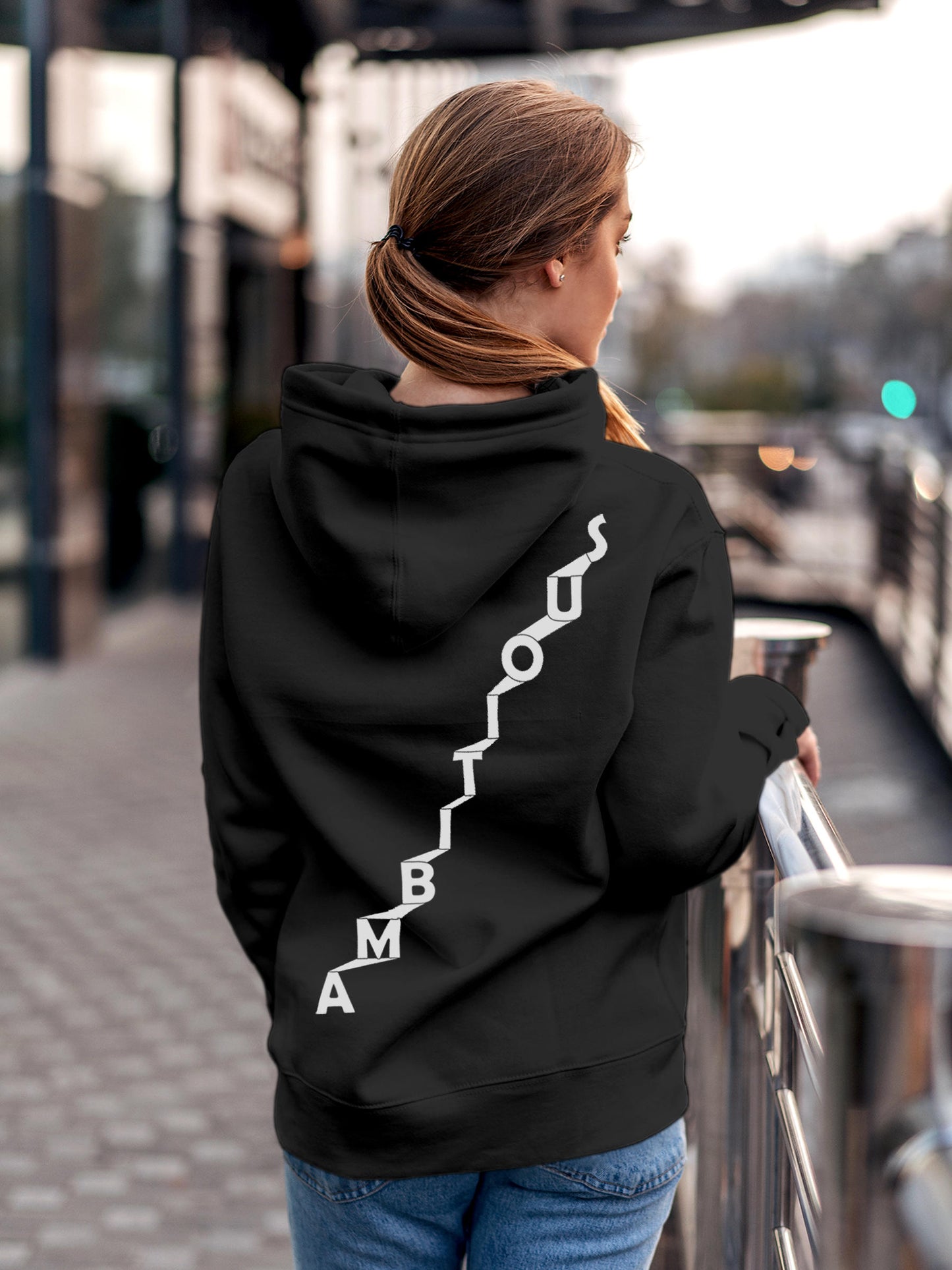 Model wearing Women's Dark Grey Hoodie Sweatshirt with 'Ambitious' design, offering effortless style and premium comfort