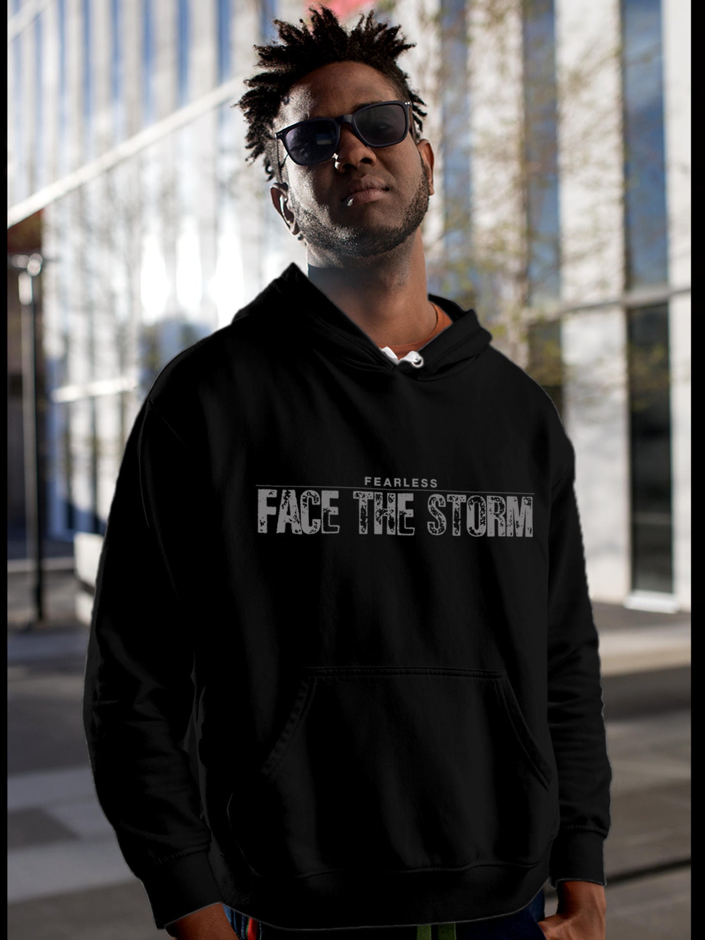 Model wearing Men's Black Hoodie Sweatshirt with 'Fearless. Face the Storm' design, offering effortless style and premium comfort