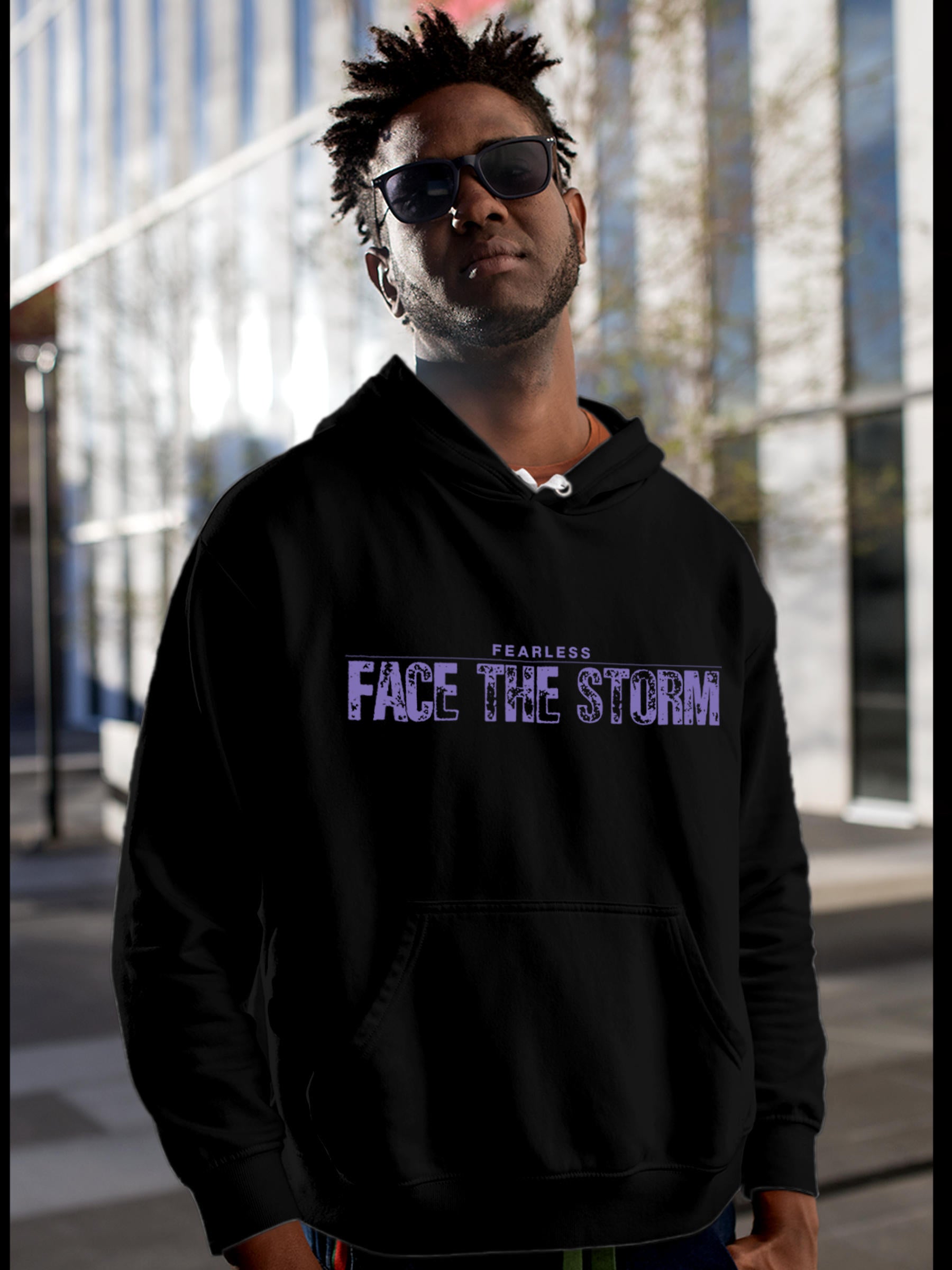 Model wearing Men's Black Hoodie Sweatshirt with 'Fearless. Face the Storm' design, offering effortless style and premium comfort