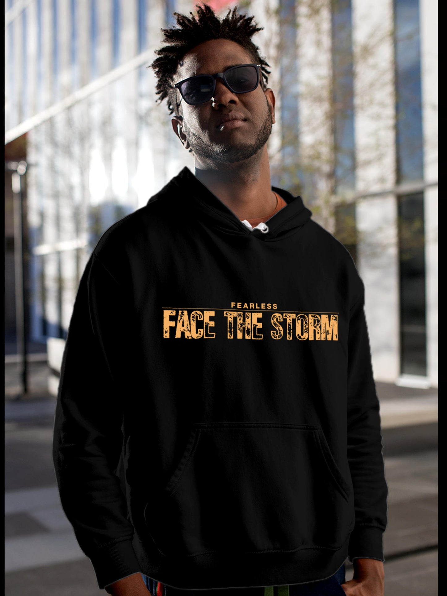 Model wearing Men's Black Hoodie Sweatshirt with 'Fearless. Face the Storm' design, offering effortless style and premium comfort
