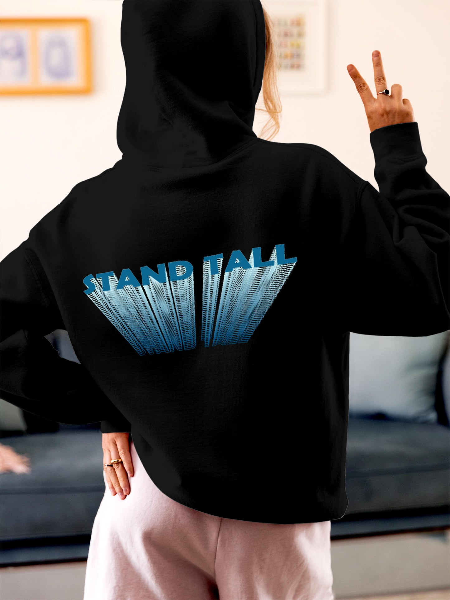 Model wearing Women's Black Hoodie Sweatshirt with 'Stand Tall' design, offering effortless style and premium comfort