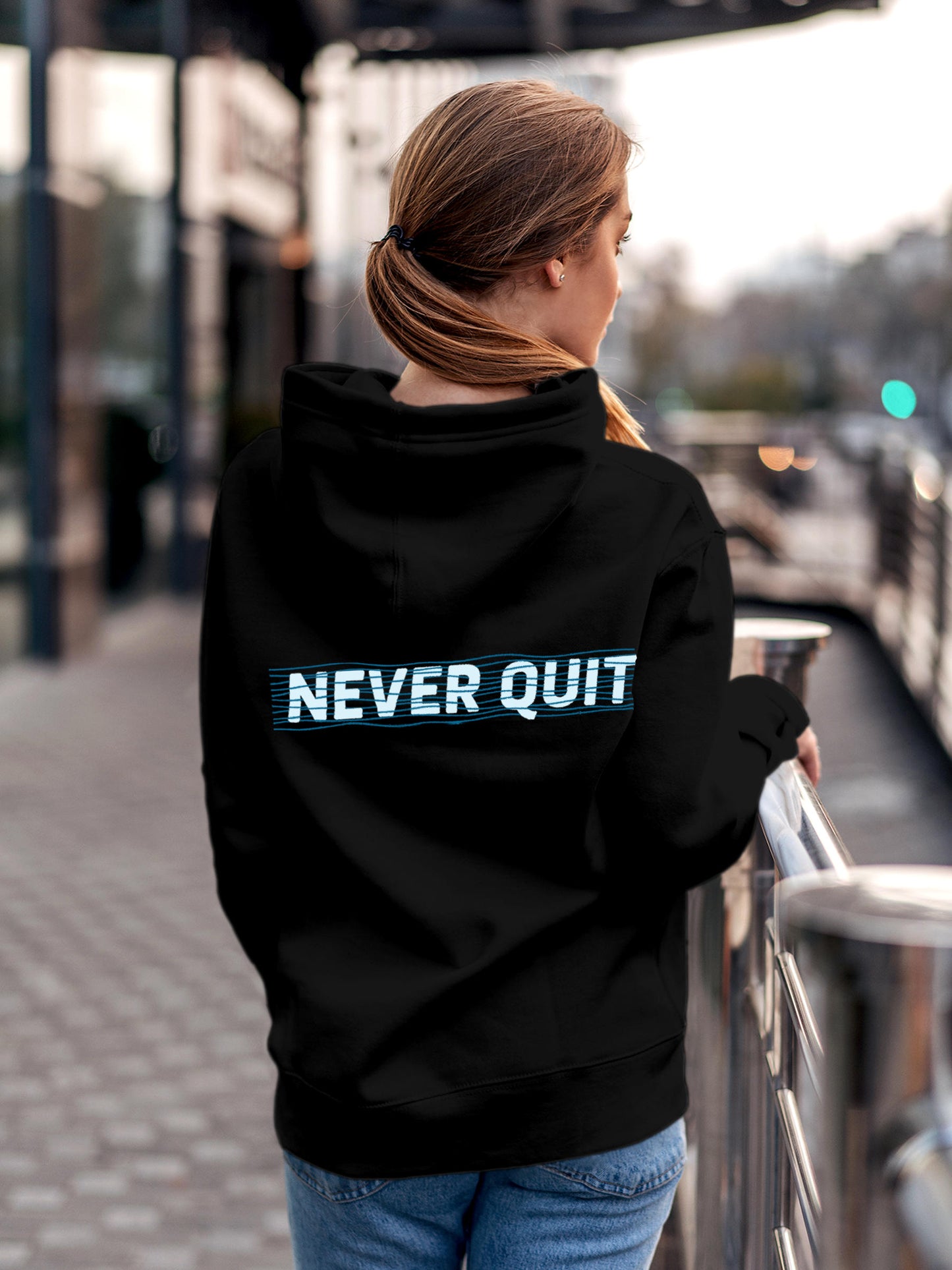 Model wearing Women's Black Hoodie Sweatshirt with 'Never Quit' design, offering effortless style and premium comfort